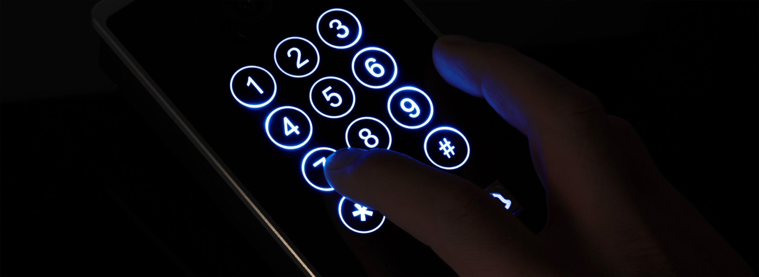 Hand hovering over phone keypad