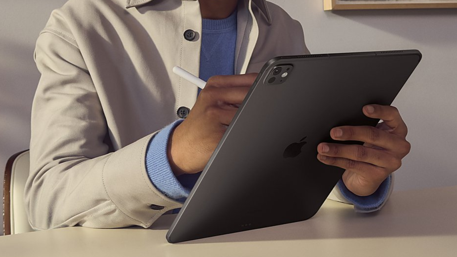 a close-up of a man writing on a 2024 apple ipad pro using an apple pencil pro