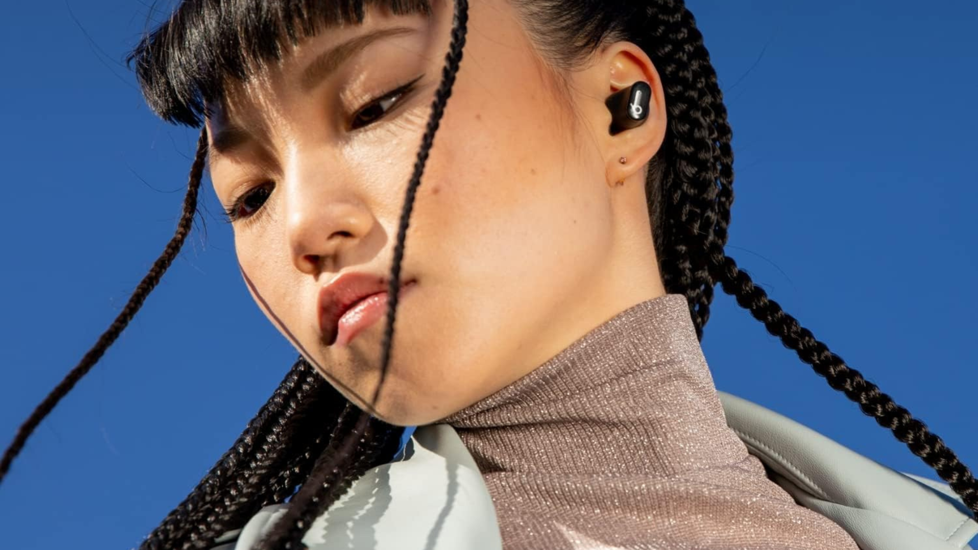 A person with Beats Studio Buds in their ears