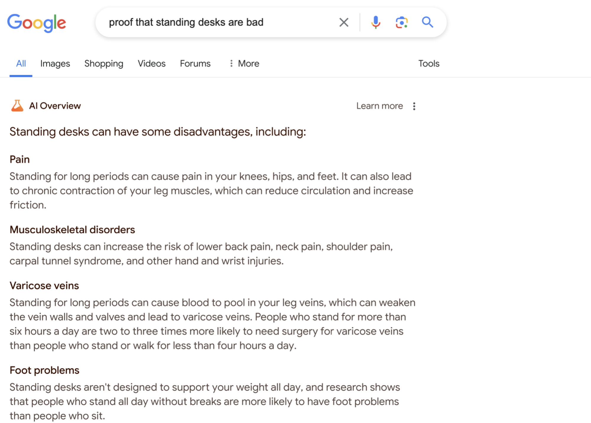the AI Overview for "proof that standing desks are bad," a pretty uncontroversial list of possible problems that could arise while using a standing desk. It says "Standing for long periods can cause pain in your knees, hips, and feet," and points to the possibilities of "Musculoskeletal disorders," and "Varicose veins."&nbsp;