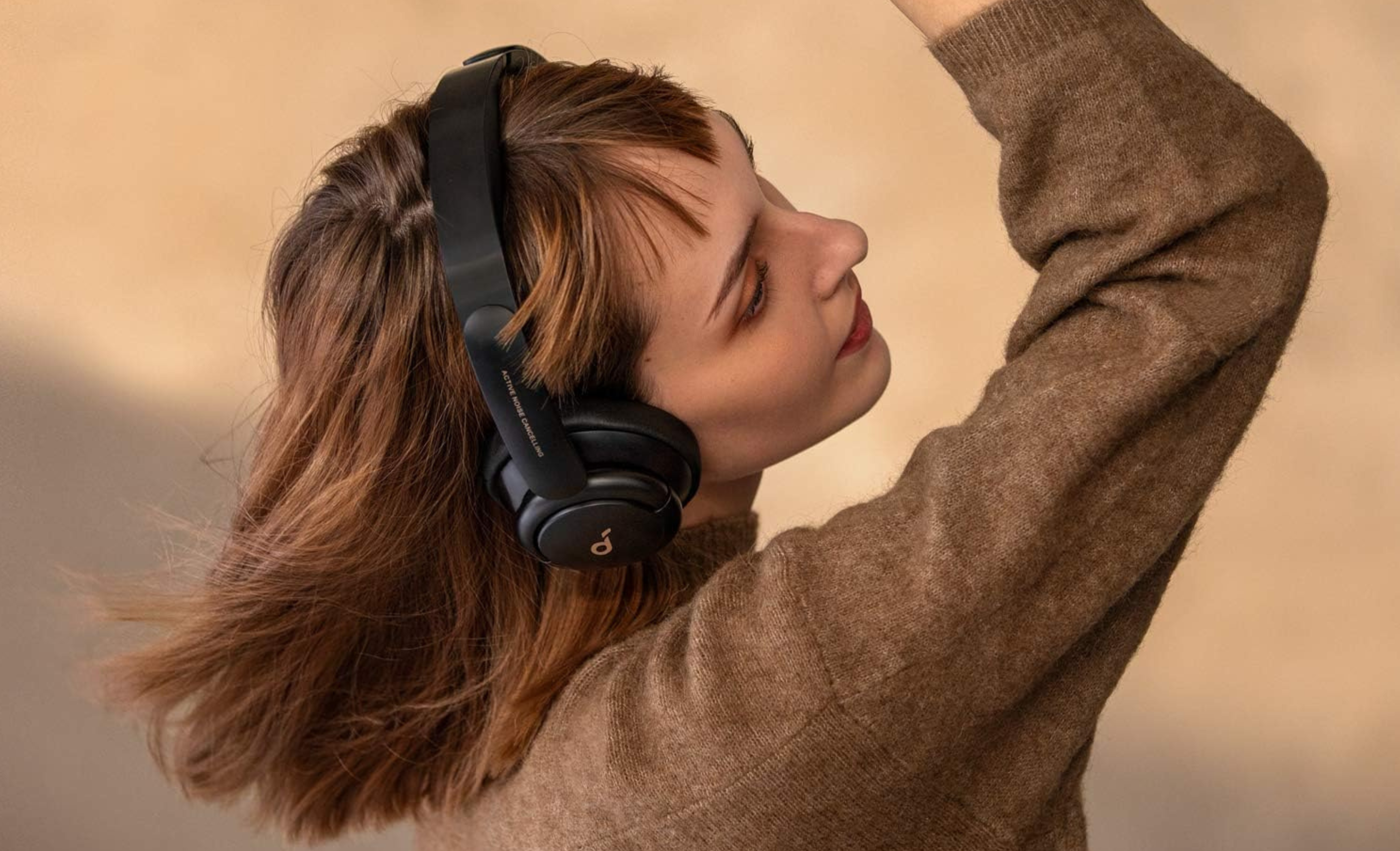 woman wearing soundcore by anker headphones