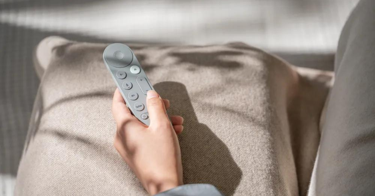 Google TV streamer remote in a person's hand 