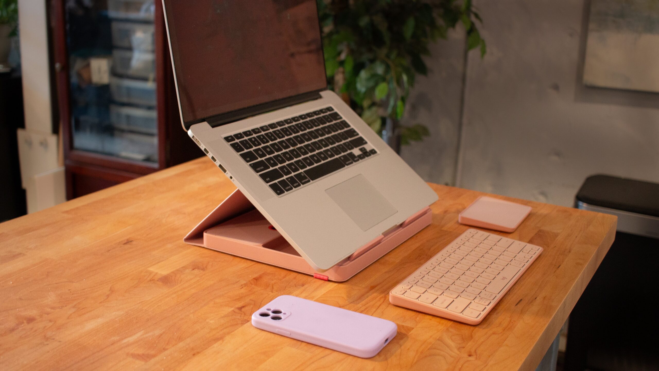 laptop set up on pink logitech casa pop-up desk