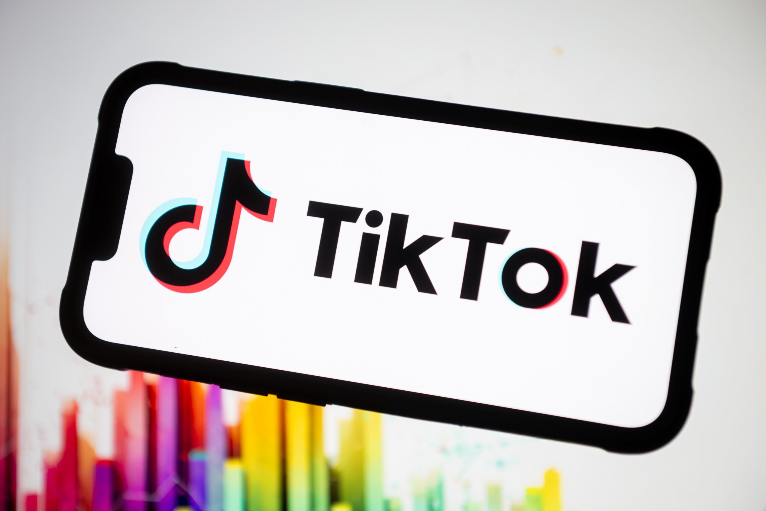 tiktok logo on a phone screen with colorful background