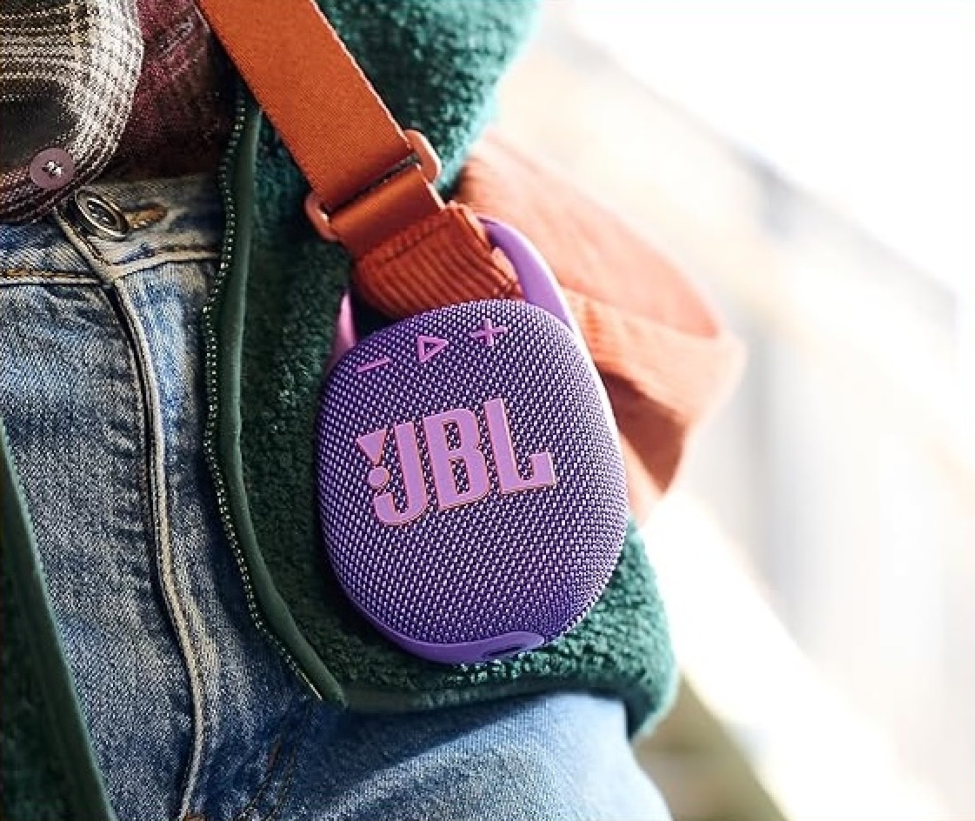 jbl speaker clipped onto a bag