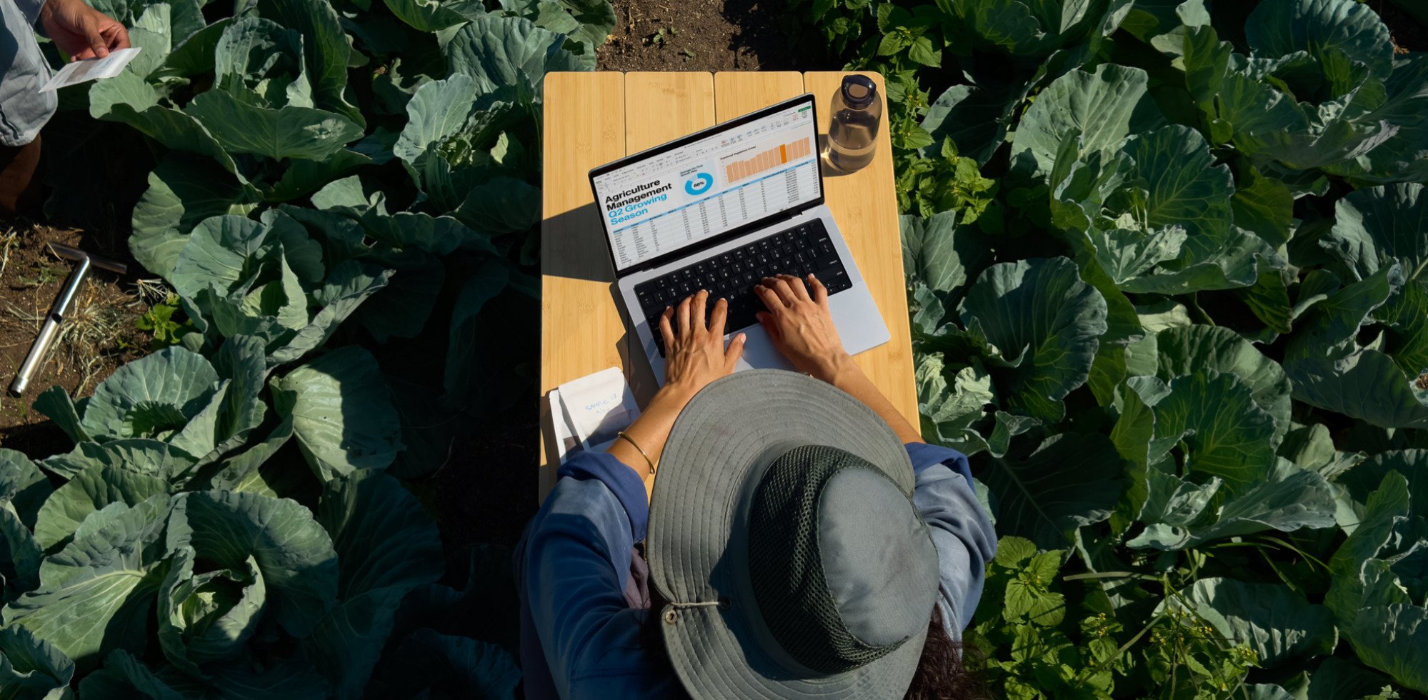 A man using the M4 MacBook Pro in a garden