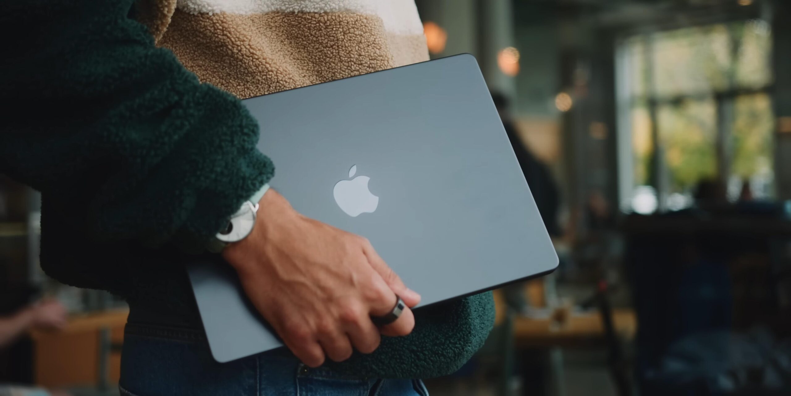 Man holding a MacBook Pro