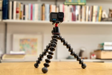 go pro hero 13 black on tripod in front of bookshelf