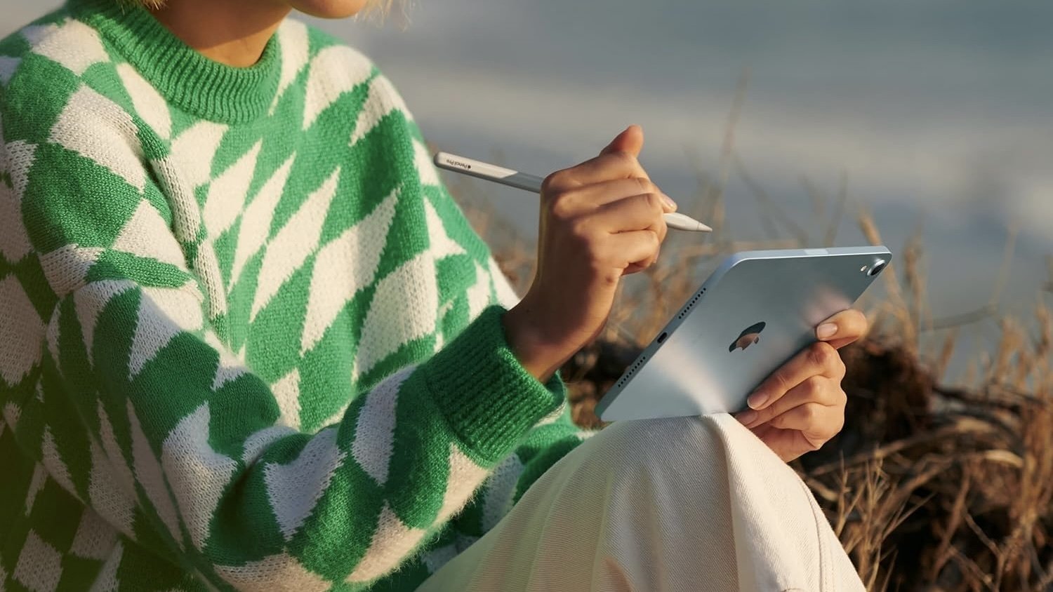 person using apple pencil on blue ipad mini released in 2024