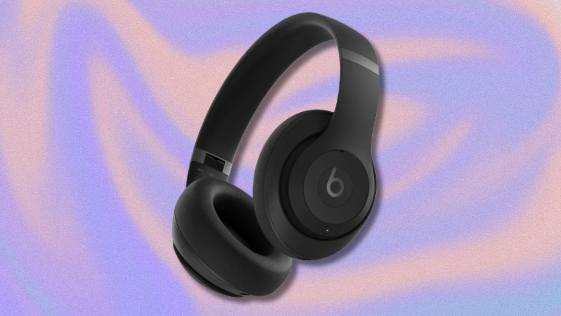 black beats studio pro headphones on a purple and orange swirling background