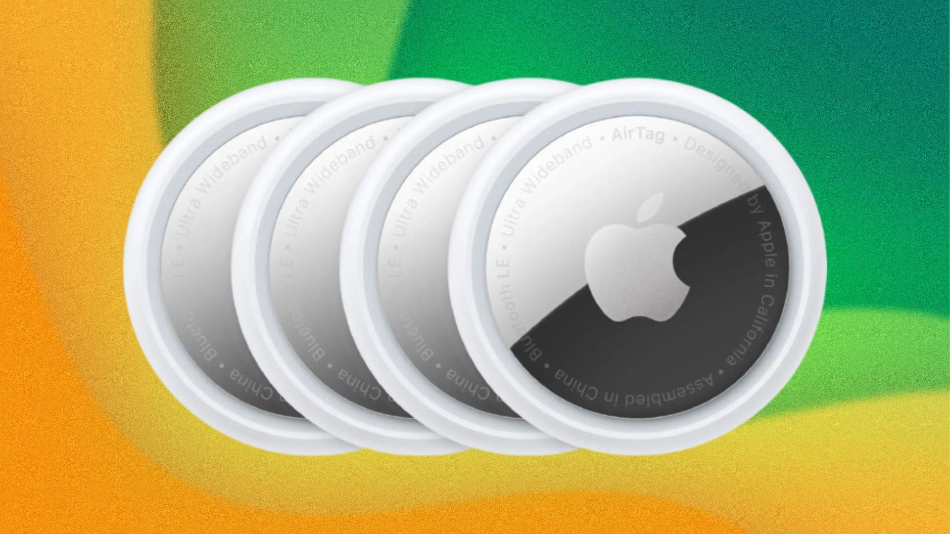 Four circular Apple AirTags appear on a green and yellow background, their metal glinting.