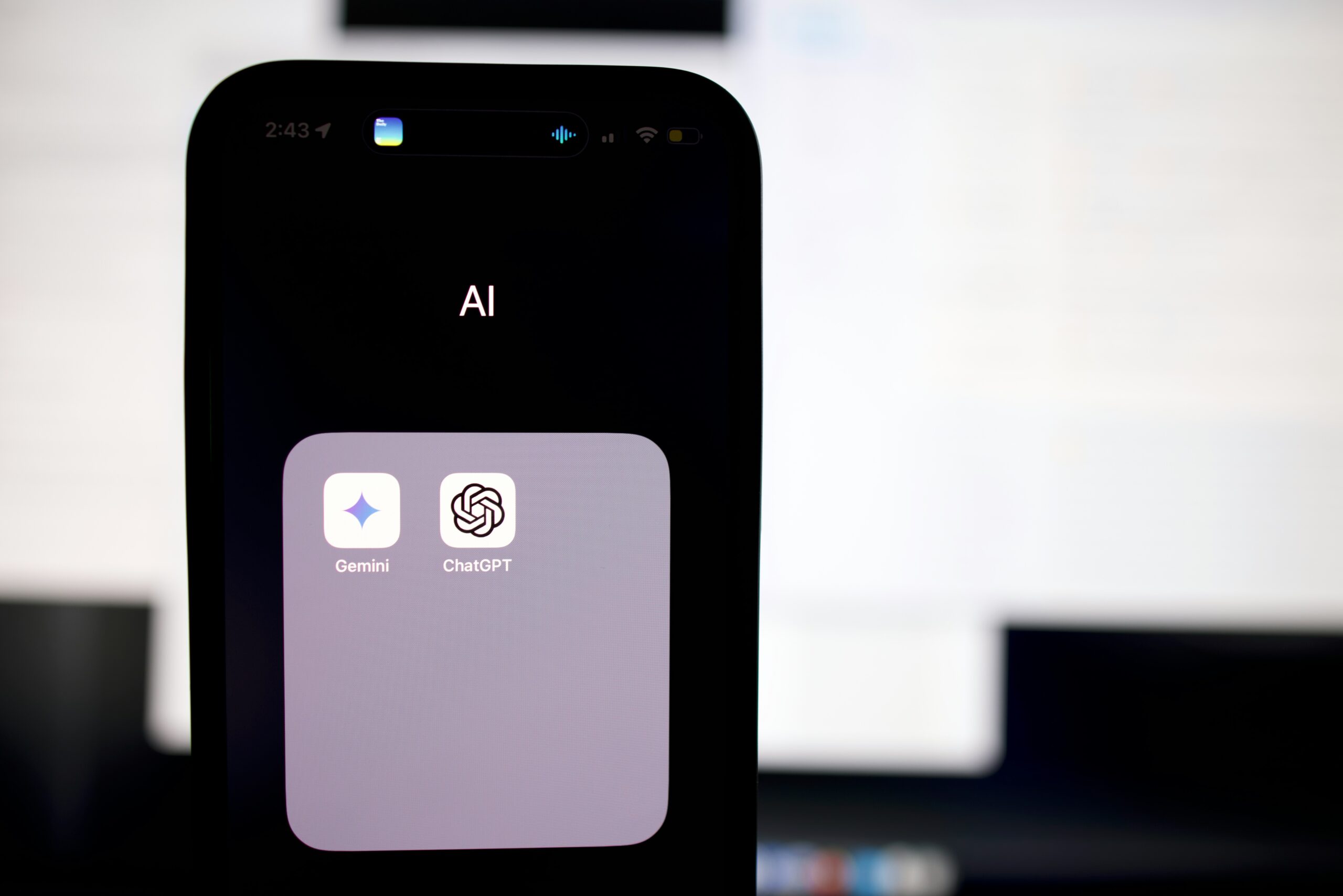 smartphone showing icons for chatgpt and gemini apps