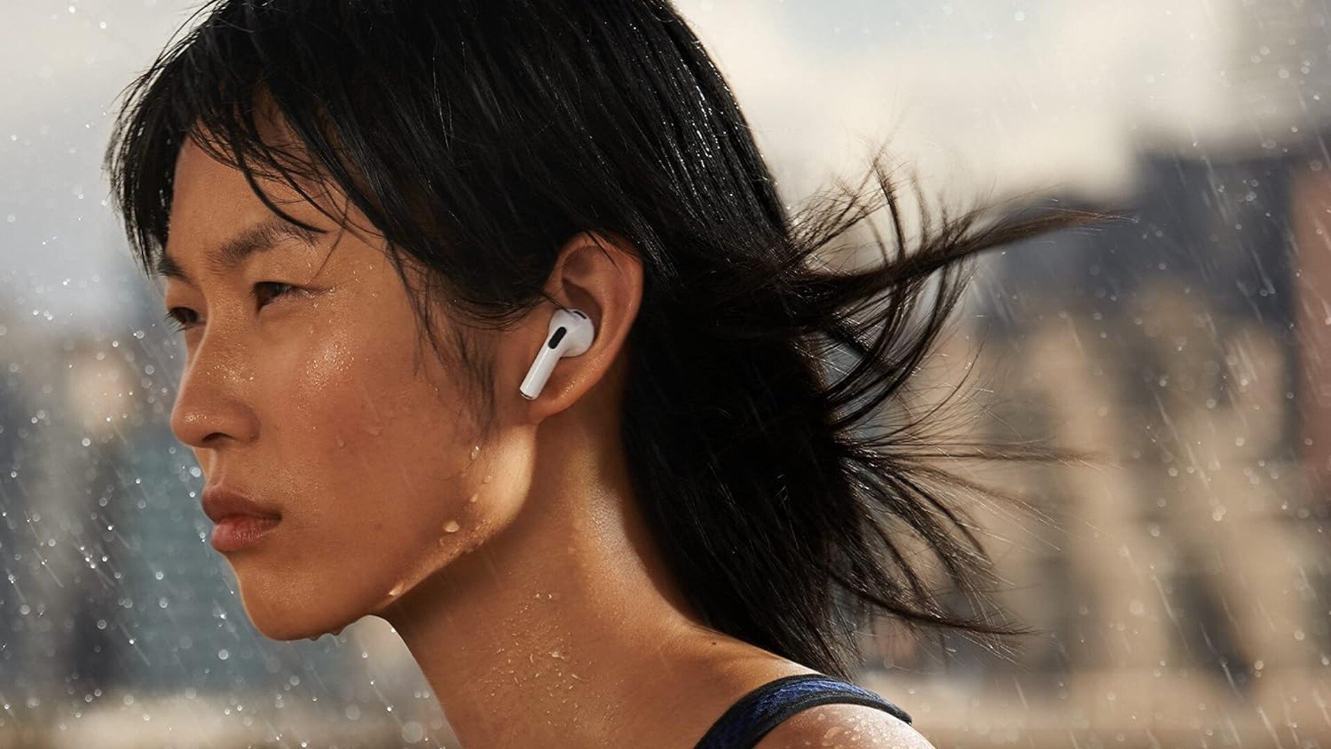women wearing apple airpods 3 in the rain