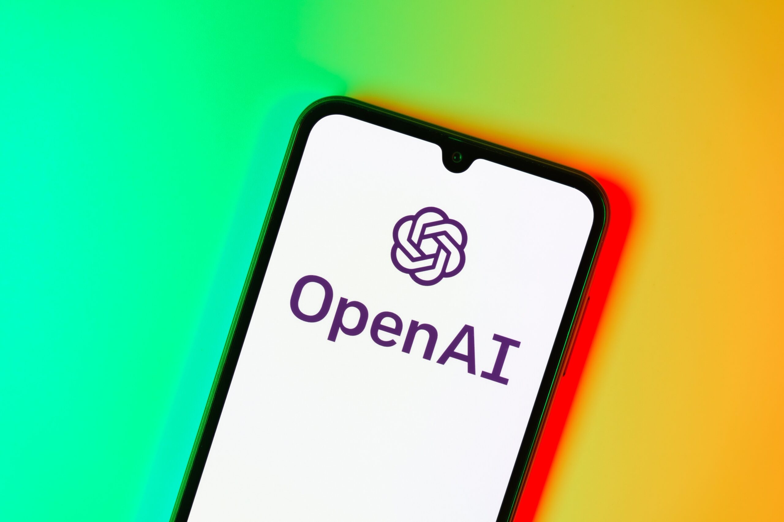 Smartphone on surface showing OpenAI logo