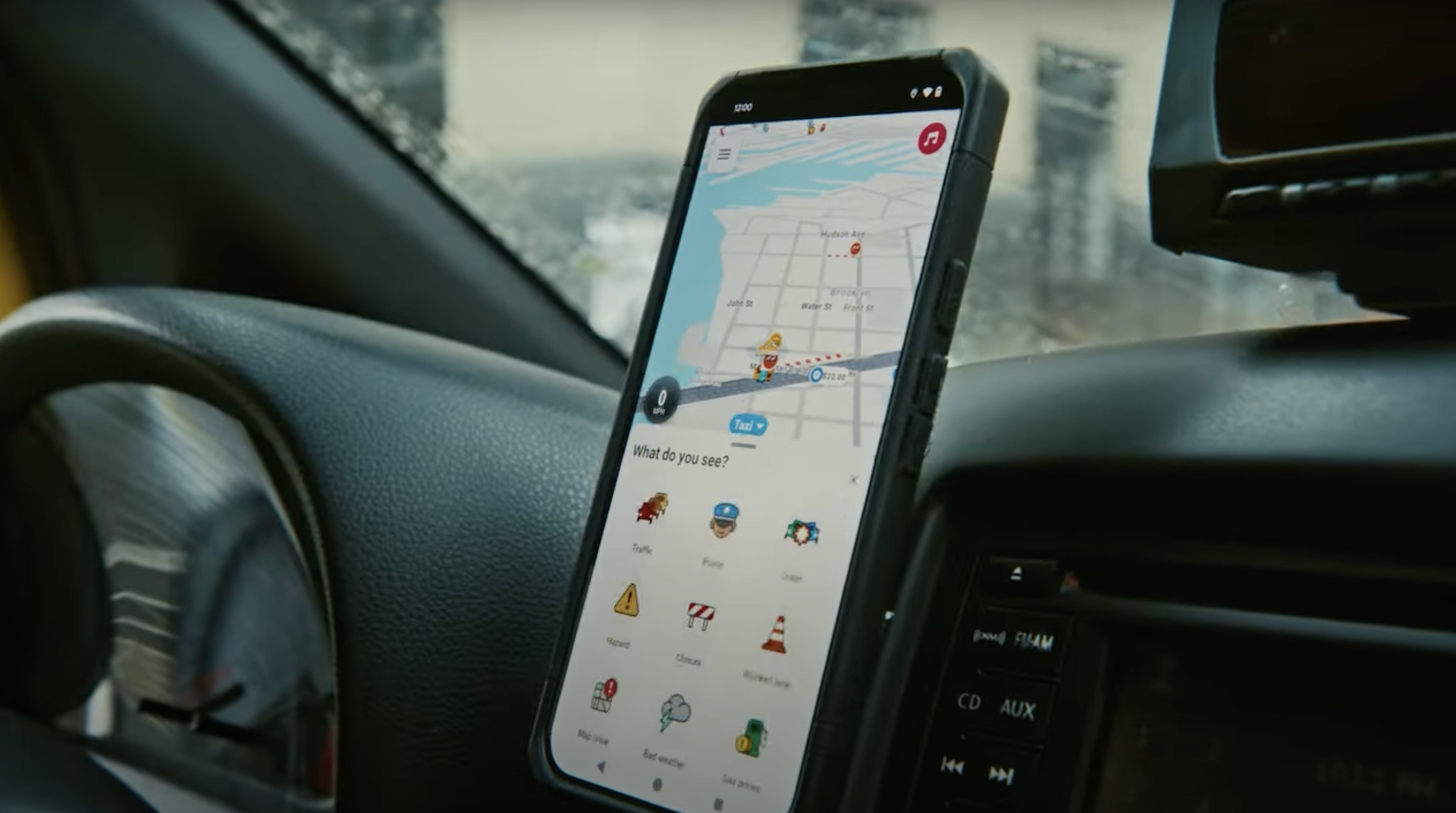 Waze app open on a smartphone mounted on a cab dashboard.