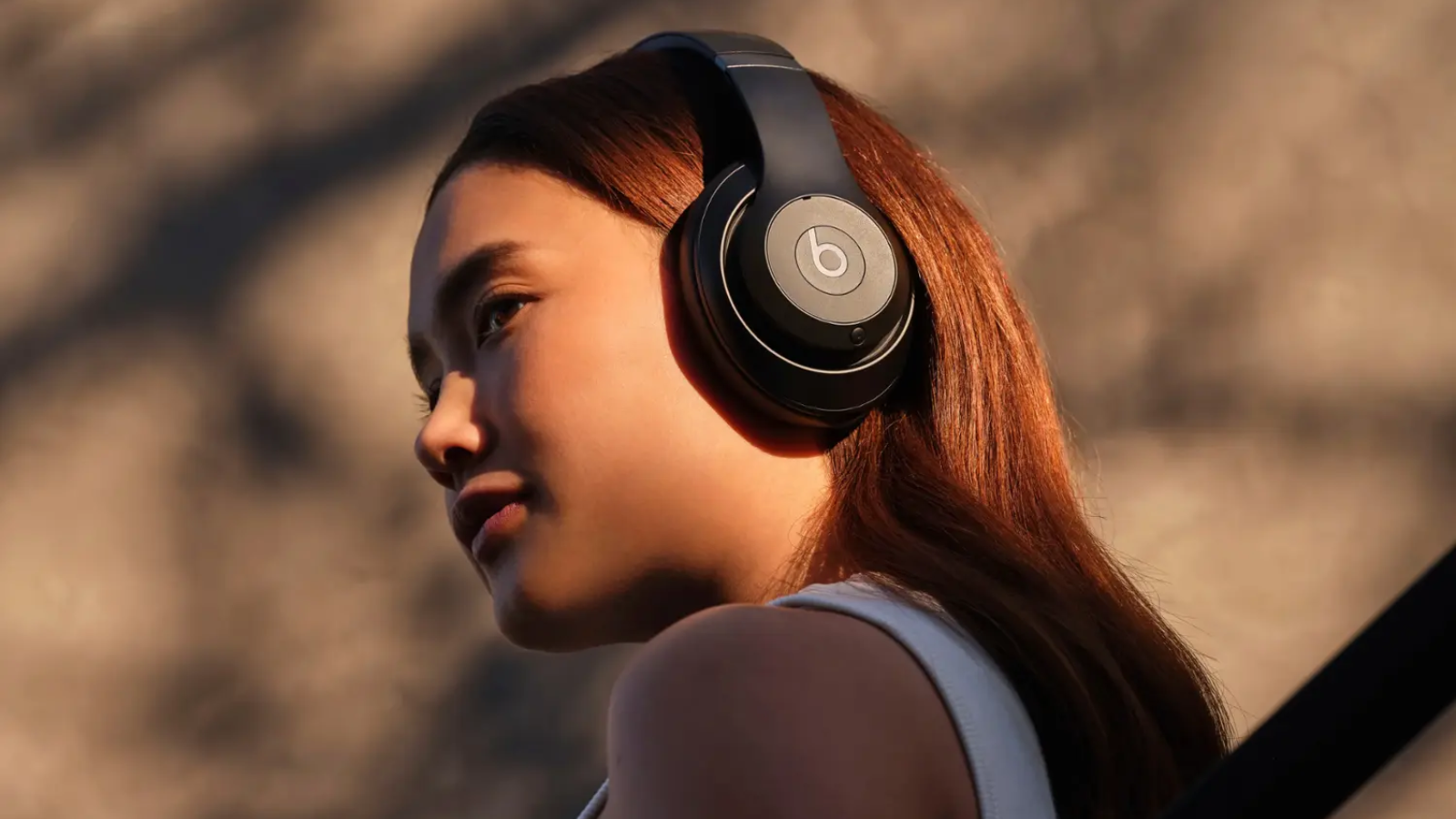 a close-up of a woman wearing beats studio pro headphones