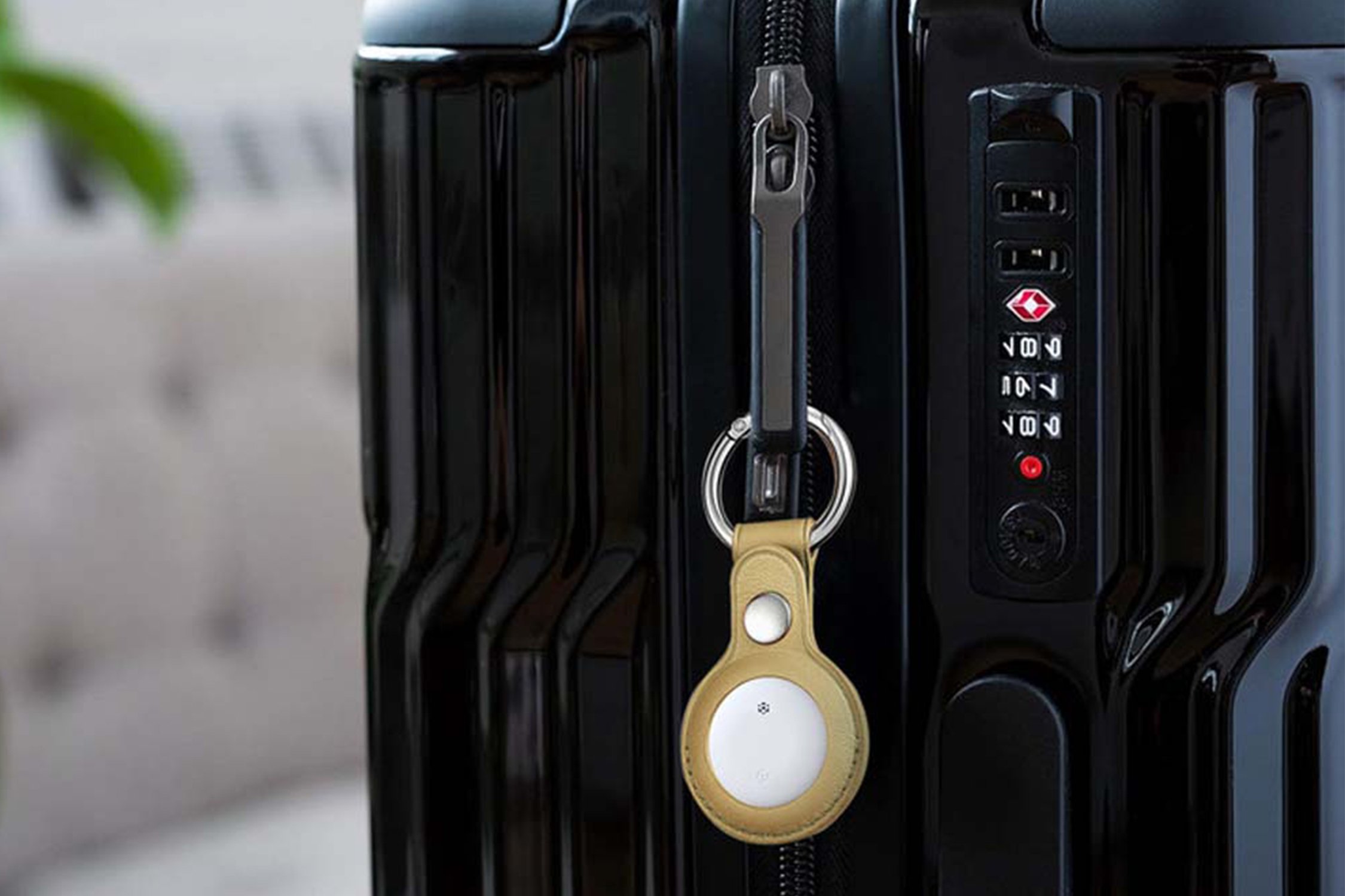 Smart Tracker on black suitcase