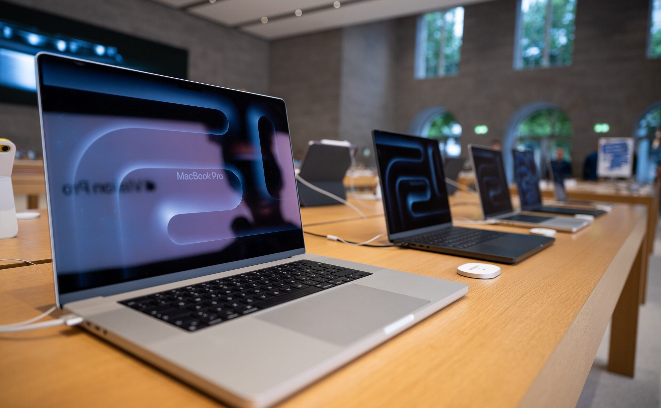 Numerous MacBook Pro laptops are on display in the Apple store on Kurfürstendamm