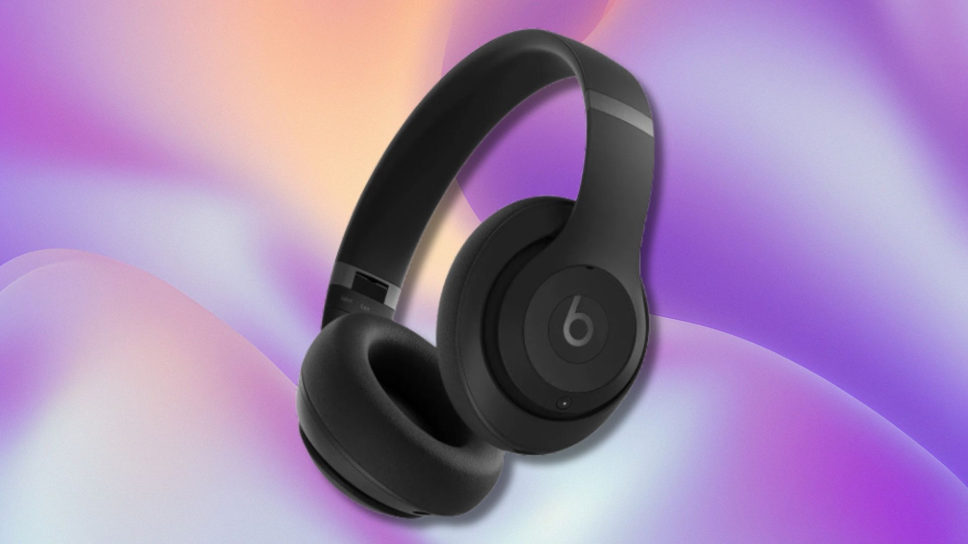 black beats studio pro headphones on a purple, light blue, and yellow wavy background