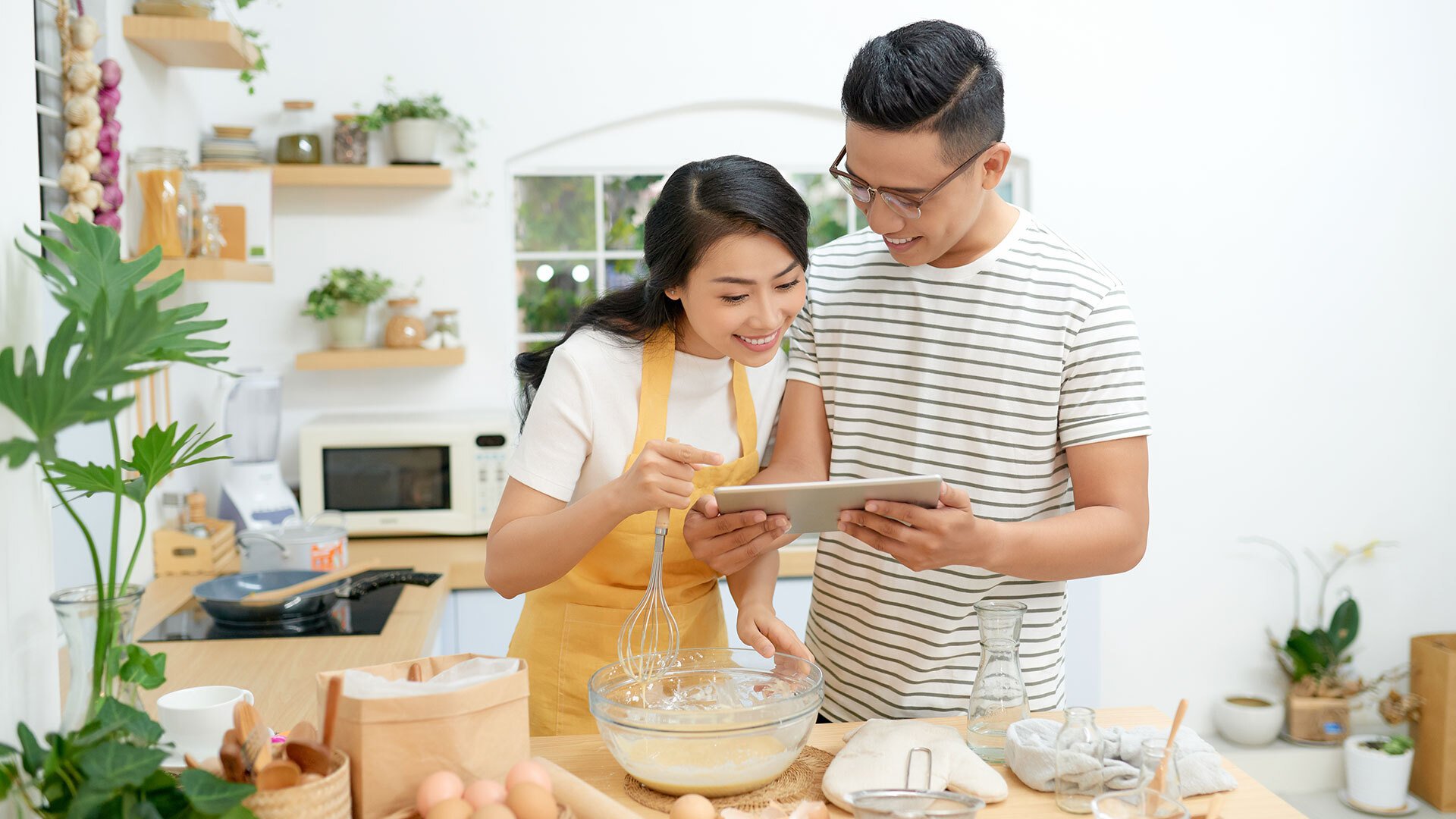 Two people looking at a tablet.