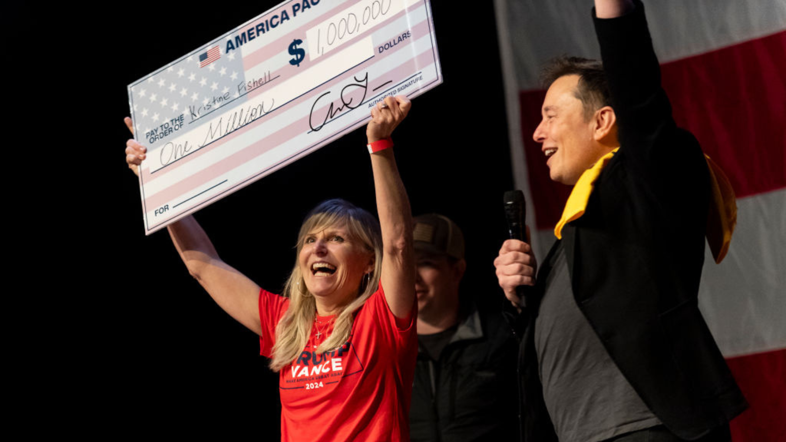 SpaceX and Tesla founder Elon Musk awarded Kristine Fishell with a $1 million check during the town hall at the Roxain Theater on October 20, 2024 in Pittsburgh, Pennsylvania.