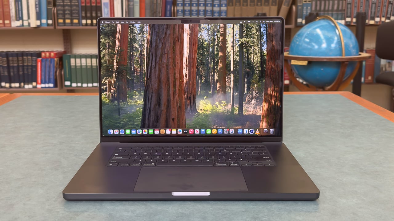 16-inch M4 Pro MacBook Pro with a library background