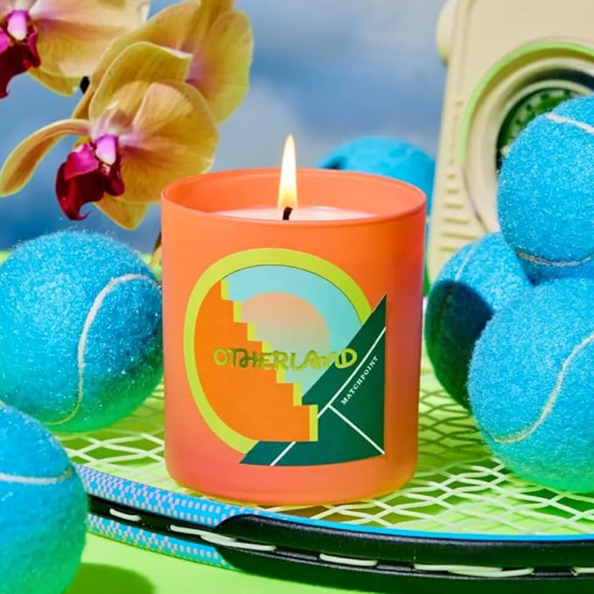 candle surrounded by tennis balls