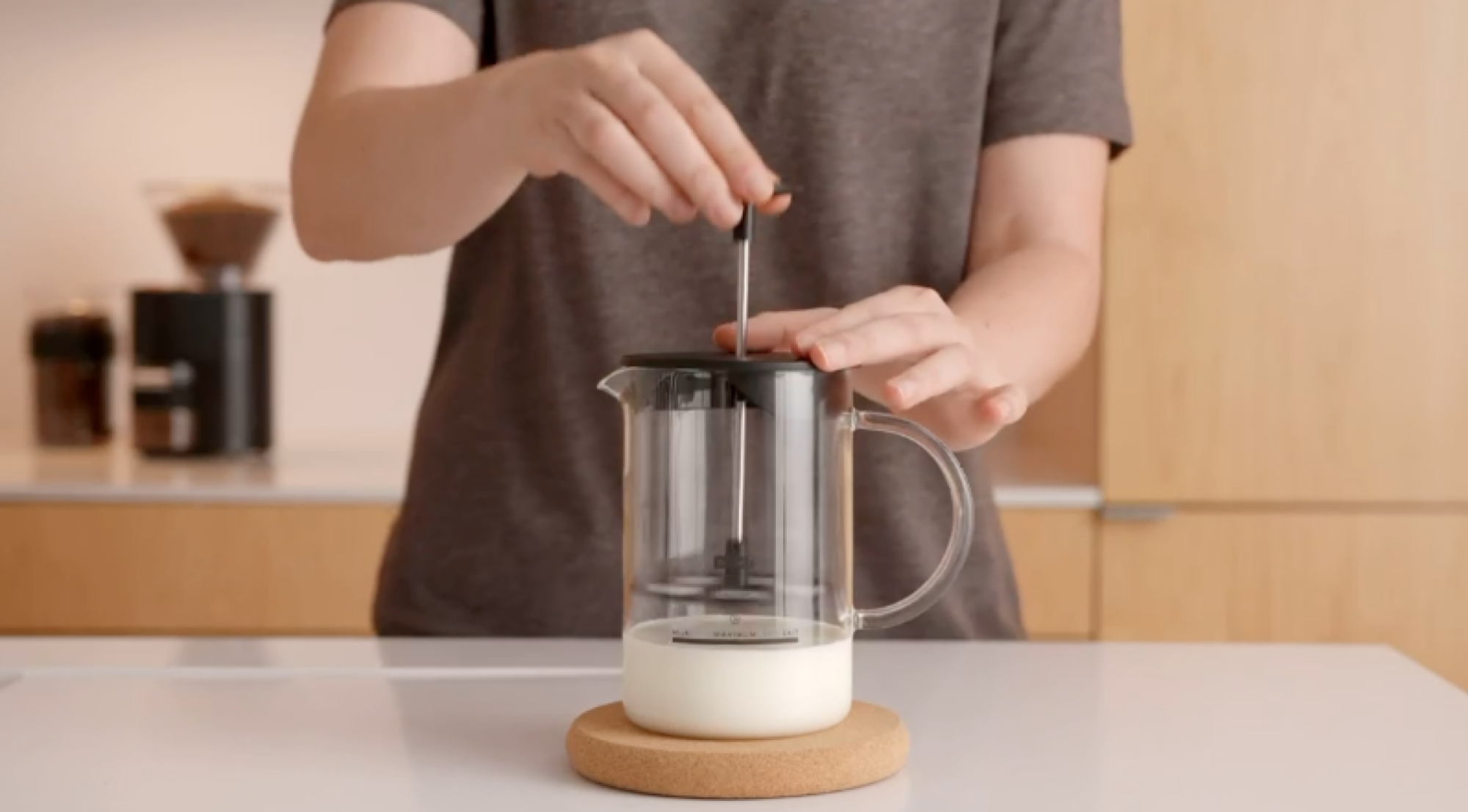 person frothing milk