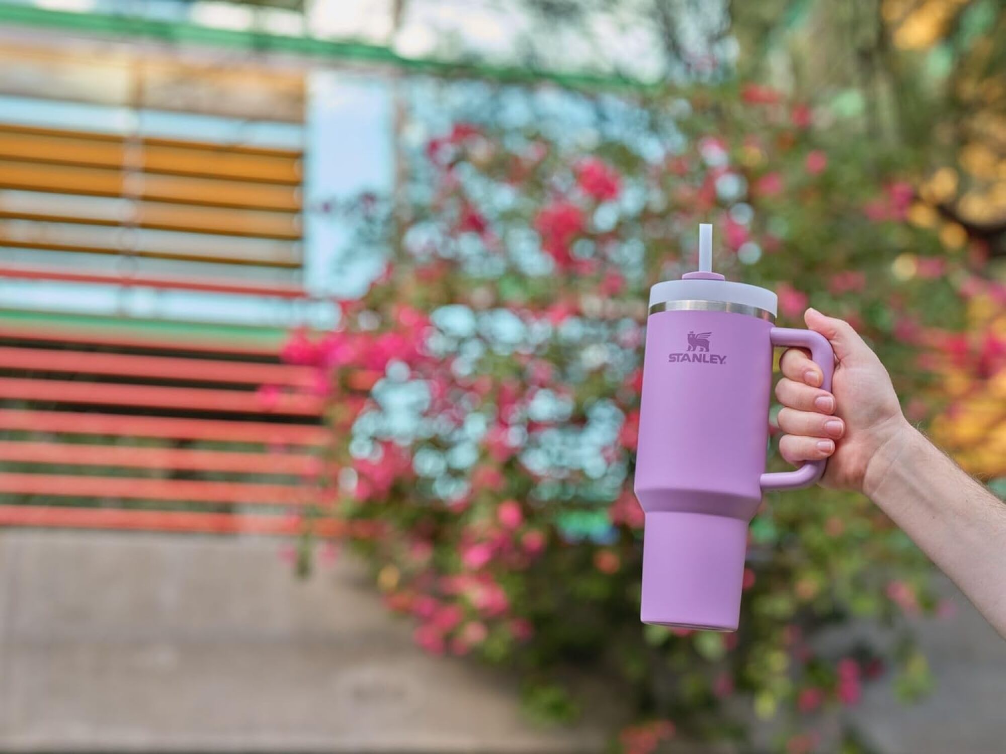 hand holding a purple stanley quencher