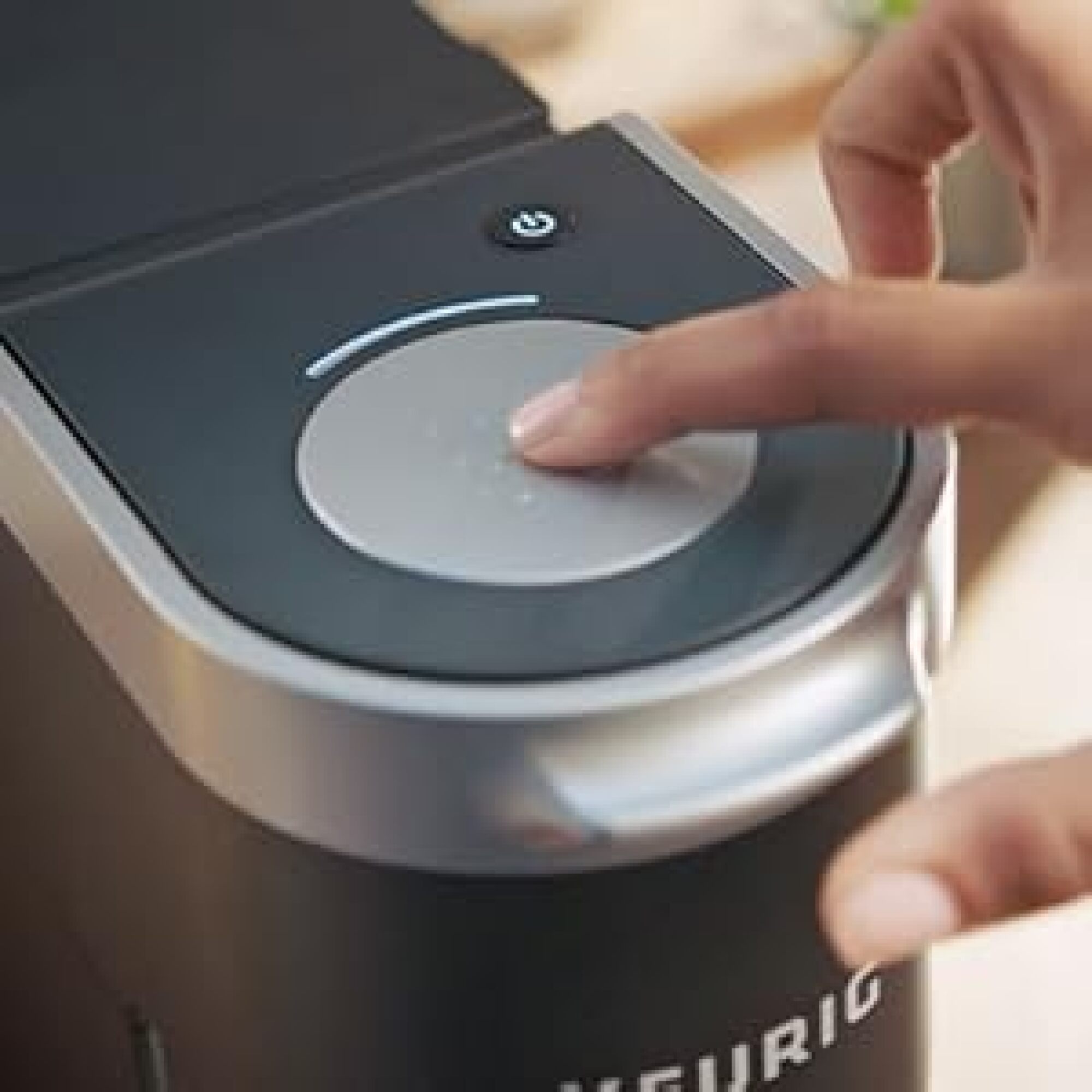 person pressing top of keurig mini