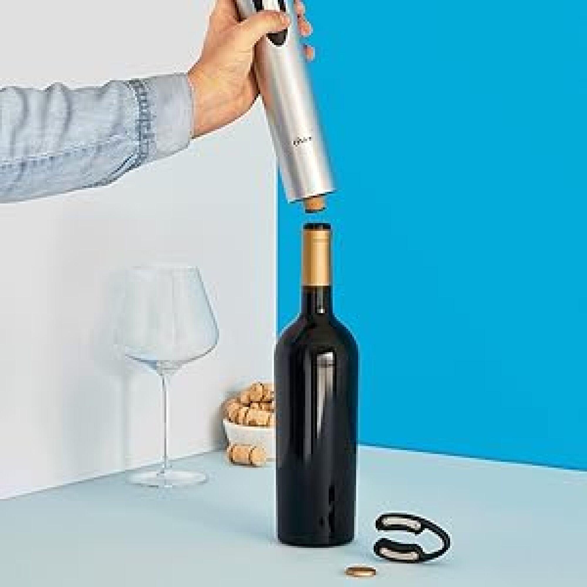 person opening a bottle of wine