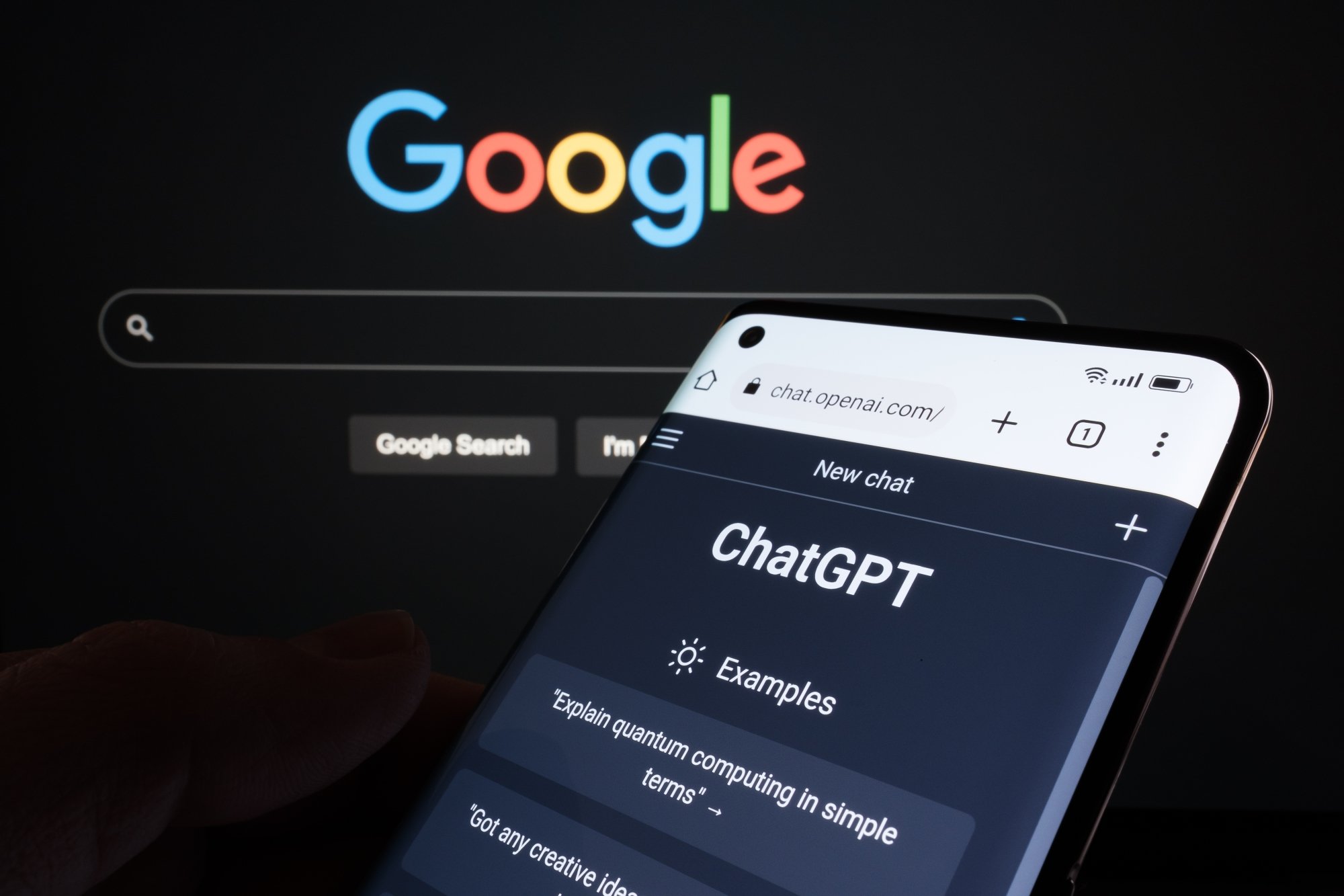 ChatGPT on a mobile device with Google webpage in the background