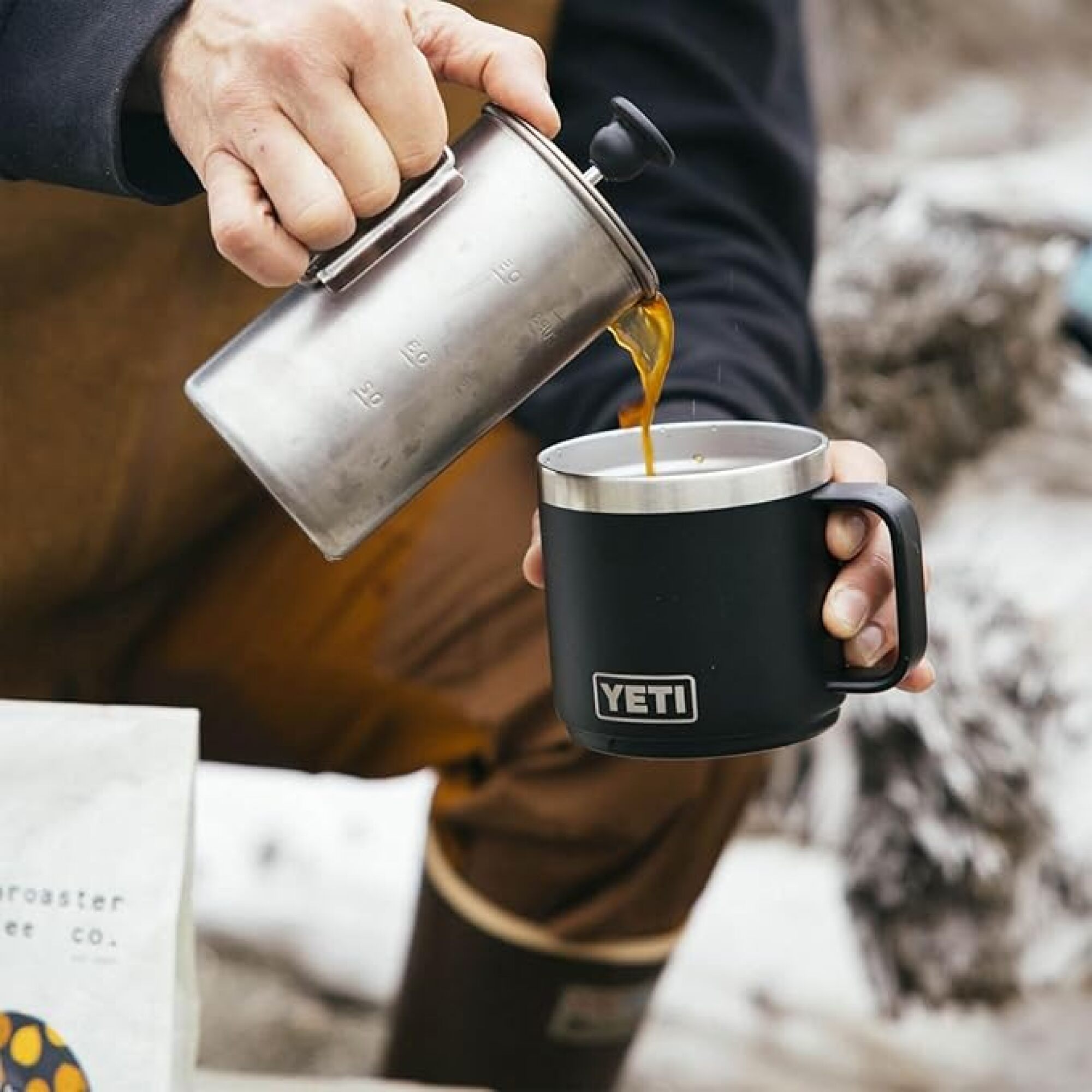 person pouring coffee into mug