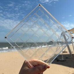 hand holding acrylic shell display