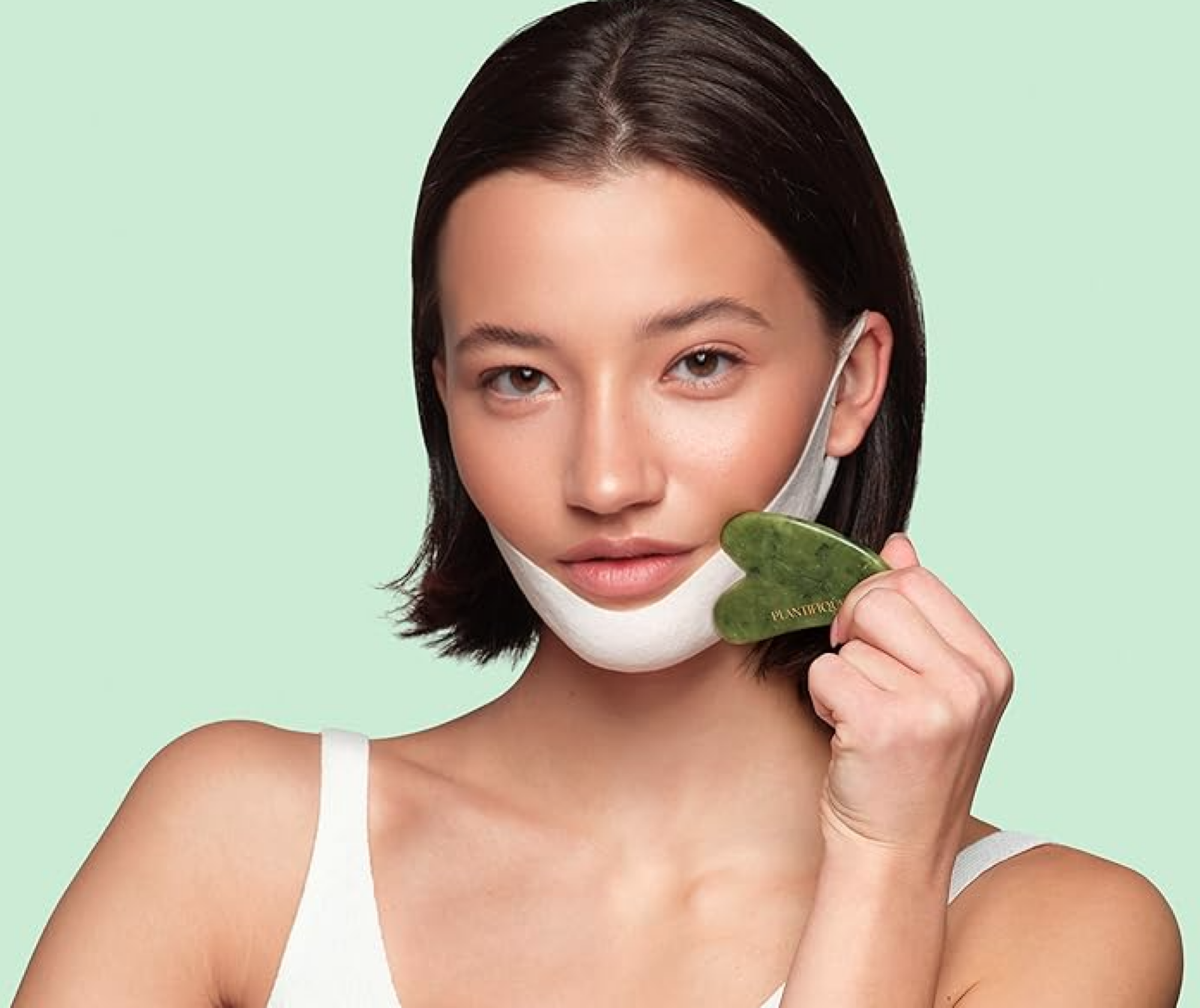 woman using gua sha and v-line mask