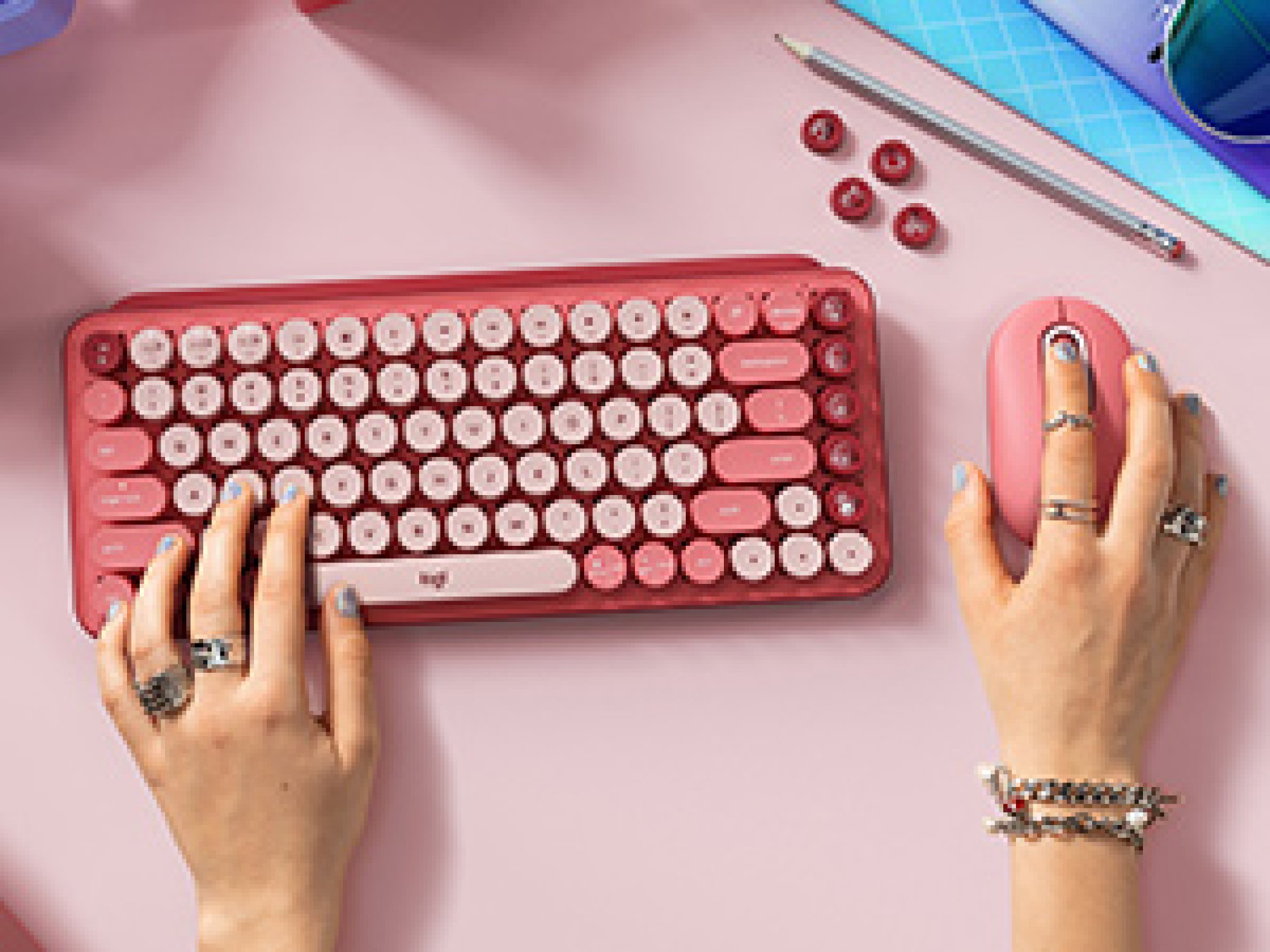 hands on pink keyboard and mouse