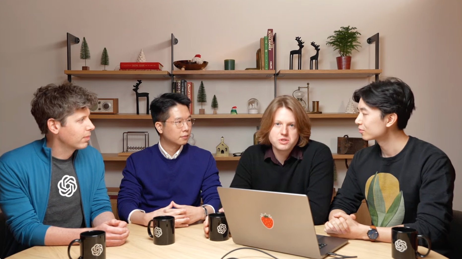 openai members seated at a table showing off a new demo