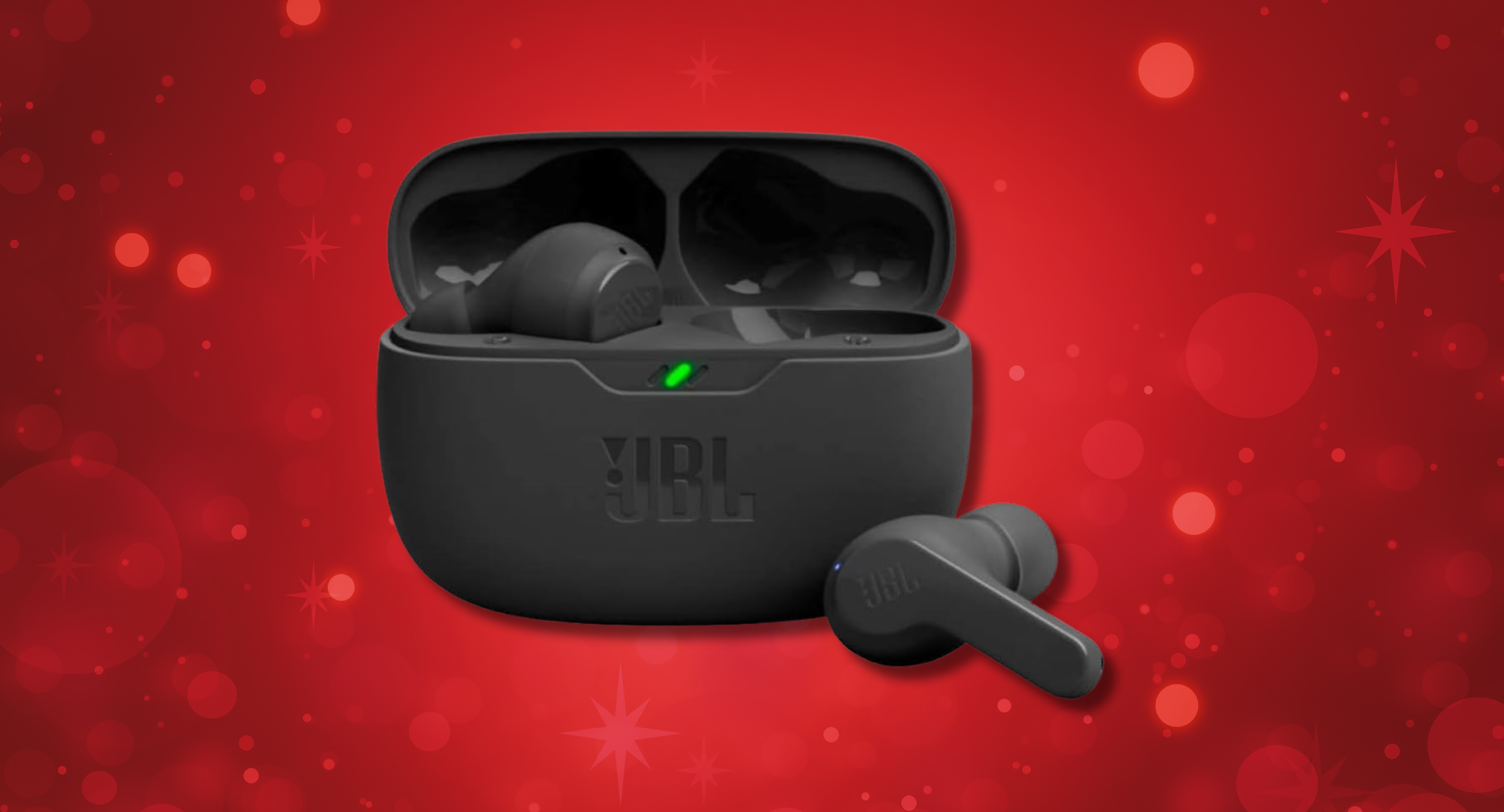 A pair of black JBL Vibe Beam earbuds sit outside their charging case on a red background with white sparkles.