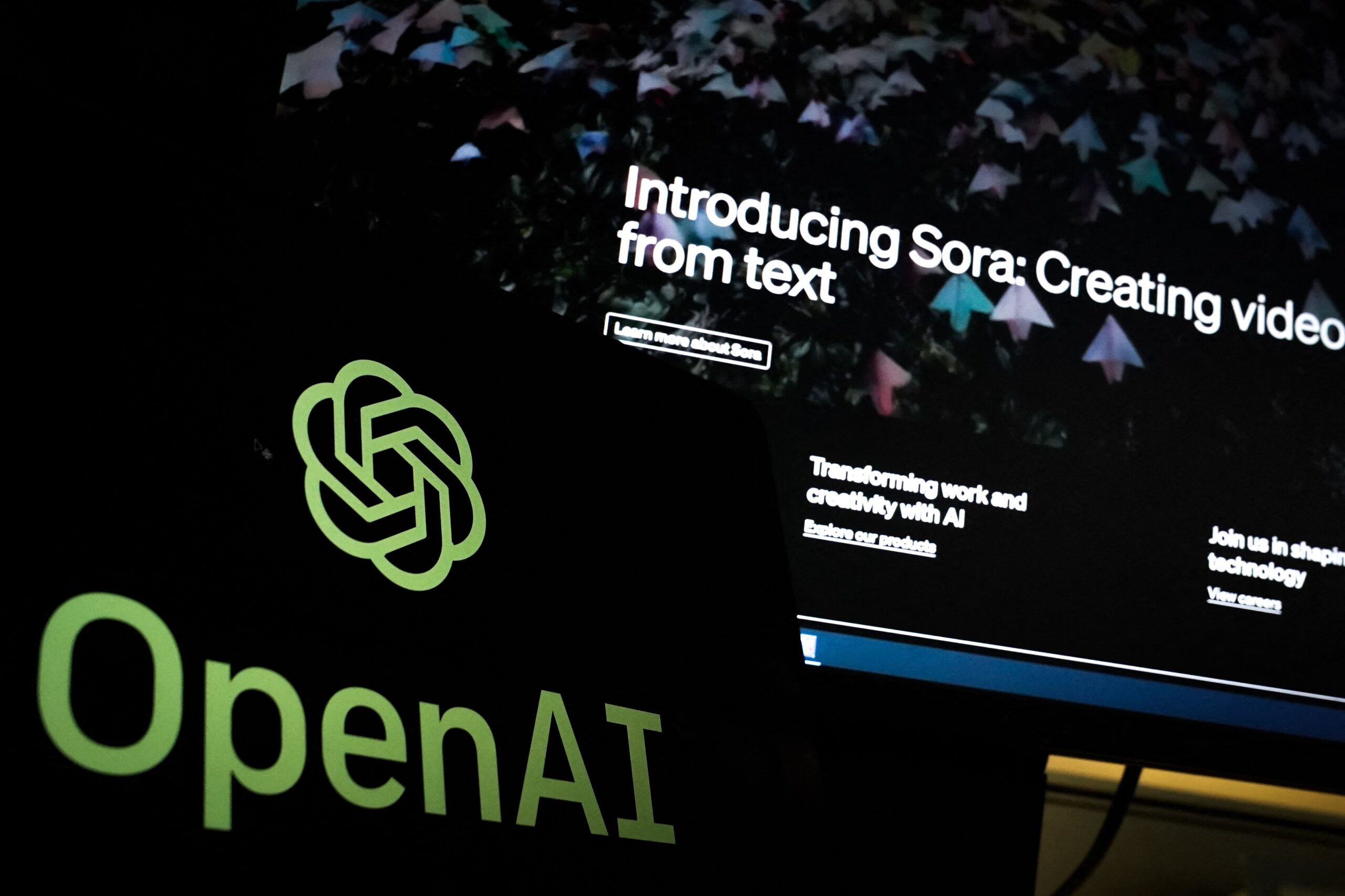 openai logo in front of screen showing sora webpage
