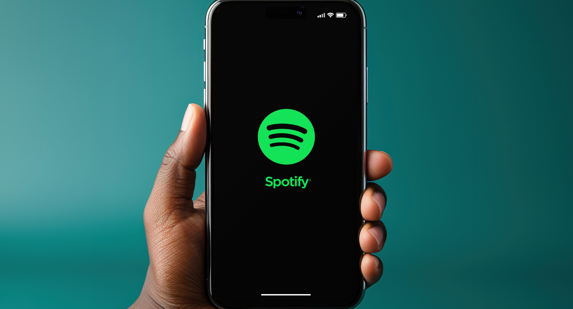 Person holding a smart phone with the spotify logo on it 