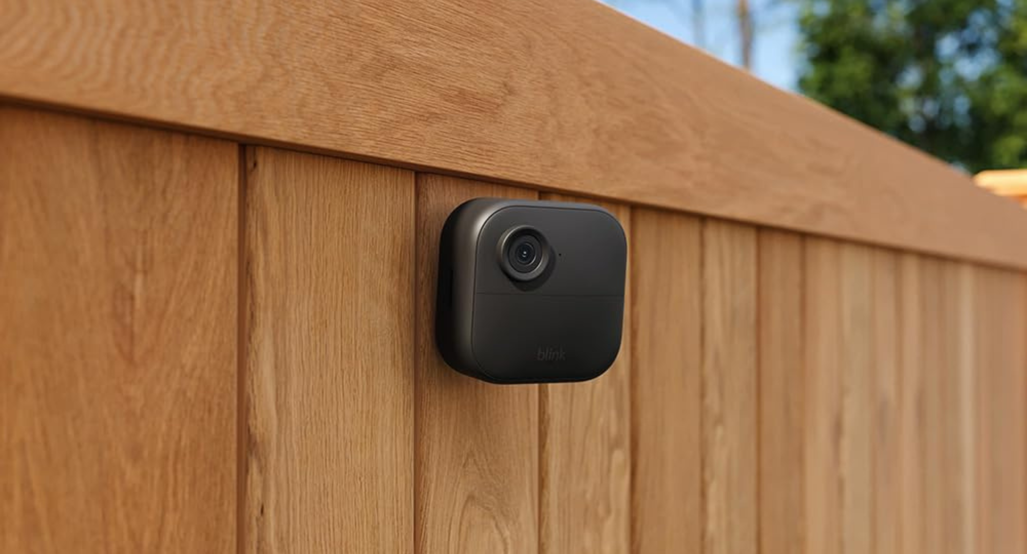 Blink outdoor camera on a wooden fence 