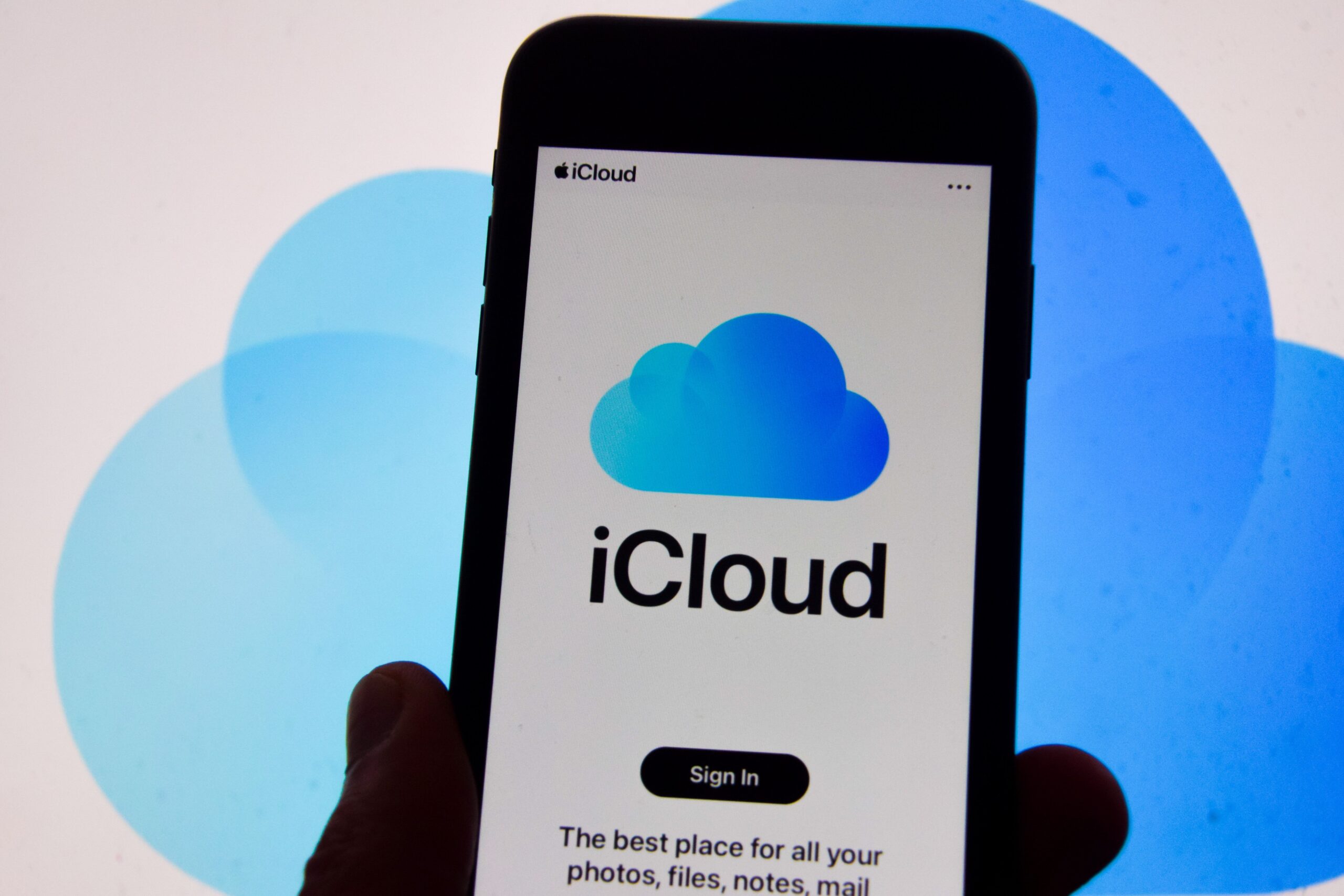 An iPhone showing the Apple iCloud login screen. 