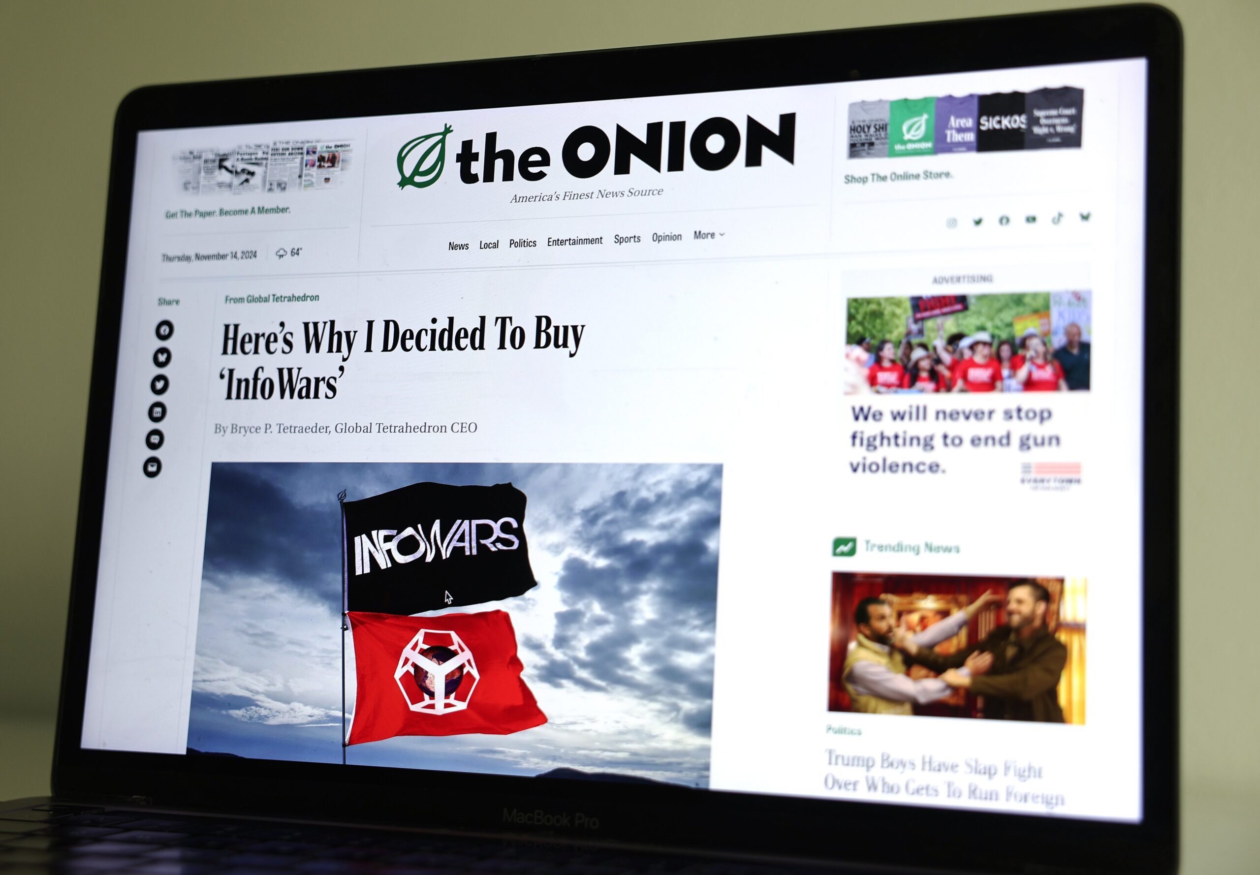 In this photo illustration, The Onion website is displayed on a computer screen, showing a satirical story titled Here’s Why I Decided To Buy ‘InfoWars’,