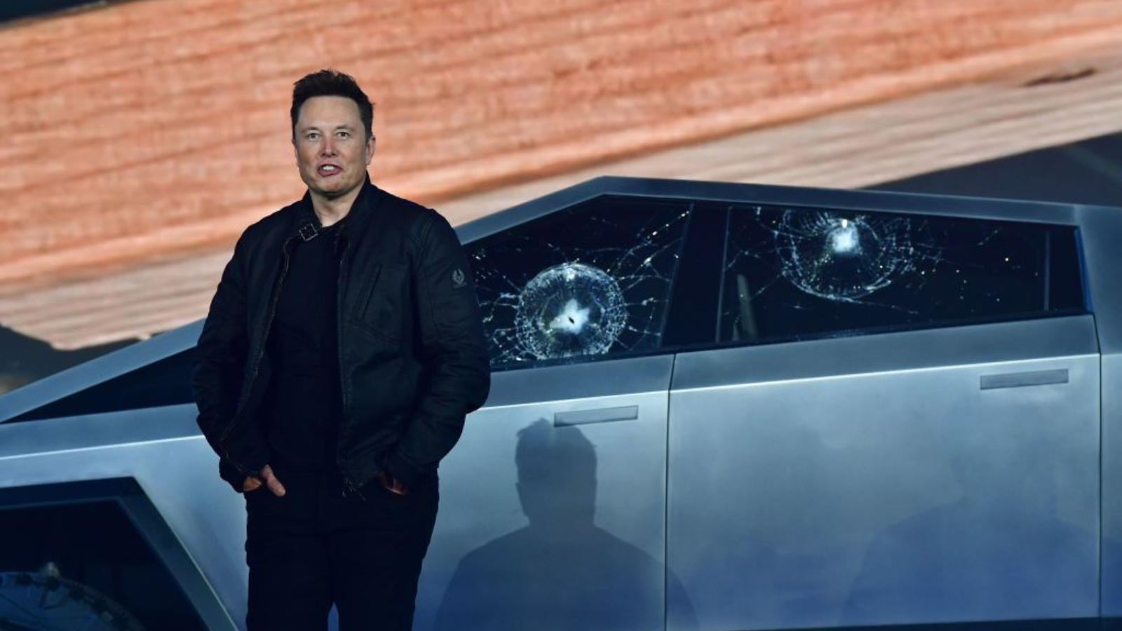 Tesla co-founder and CEO Elon Musk stands in front of the shattered windows of the newly unveiled all-electric battery-powered Tesla's Cybertruck at Tesla Design Center in Hawthorne, California on November 21, 2019.