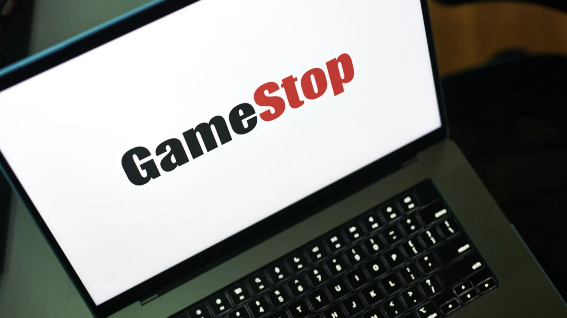 A laptop displaying the Gamestop logo.