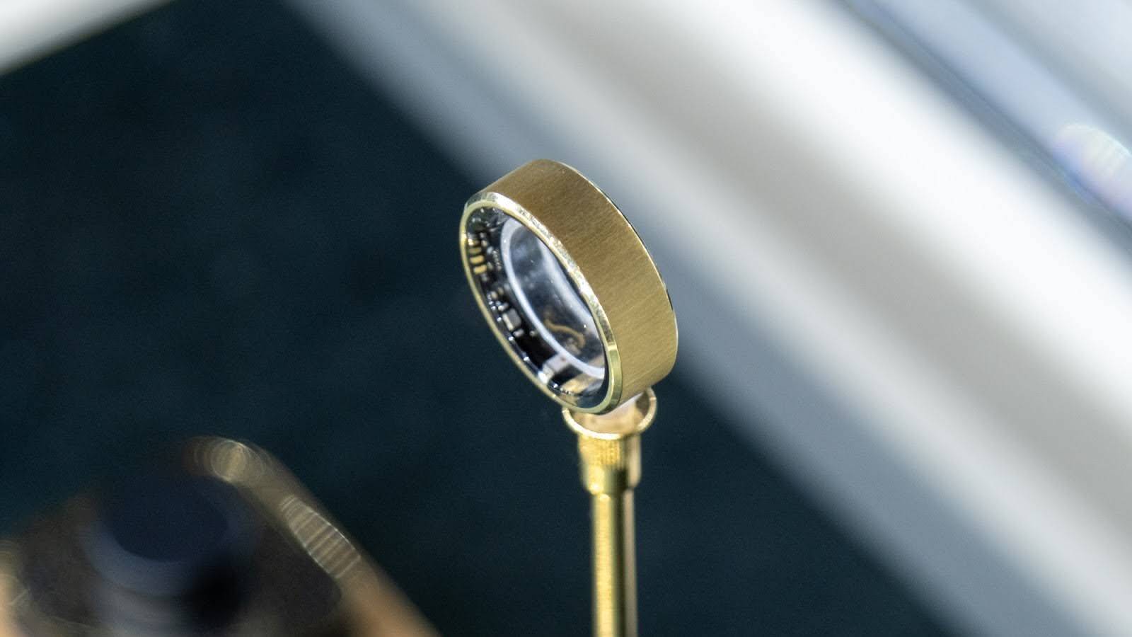 A close up of a gold ring -- the Ultrahuman Ring Air in 18K gold. 