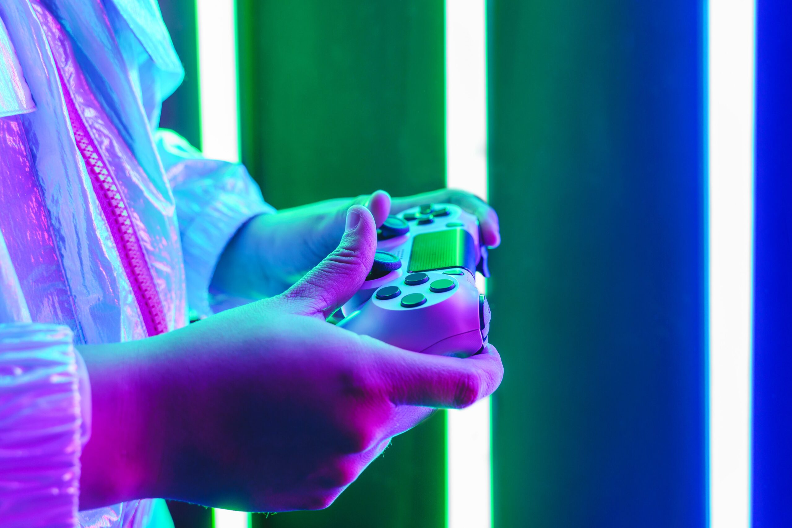 Horizontal close up view of millennial teenager hands playing immersive video games with reflective clothing. Technology and Metaverse concept