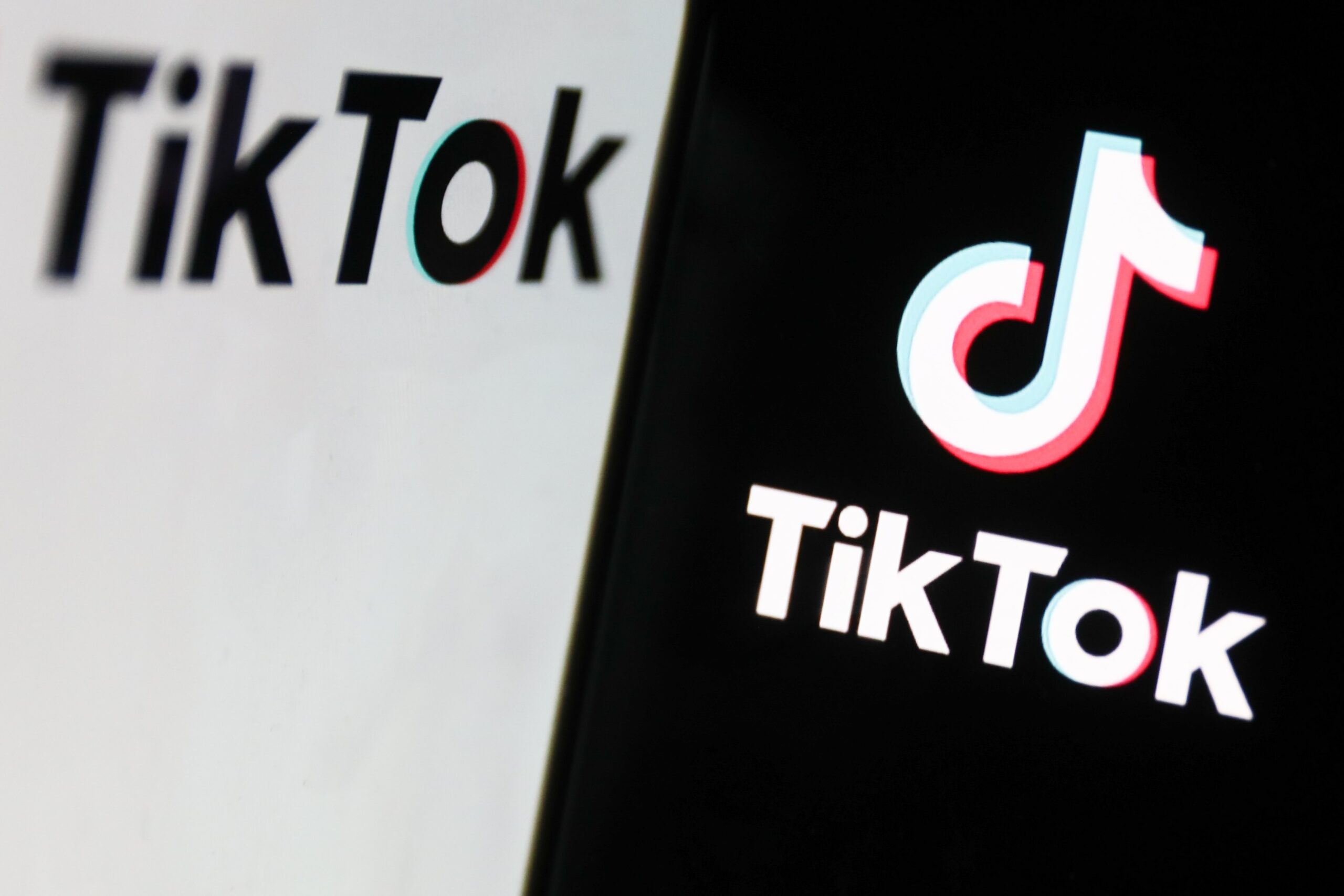 TikTok logo displayed on a laptop screen and TikTok logo displayed on a phone screen are seen in this illustration photo taken in Krakow, Poland on February 7, 2024. 