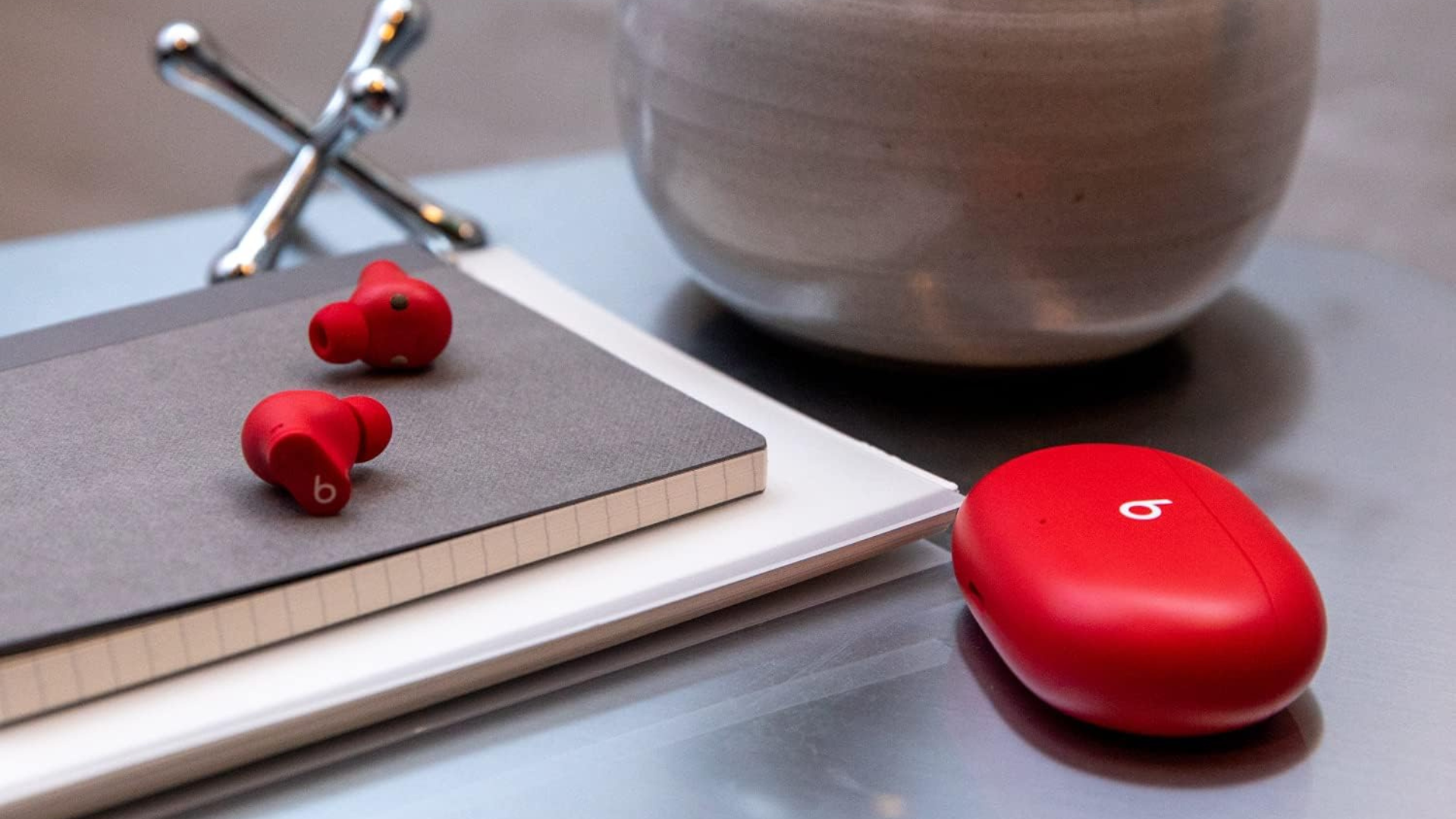 A pair of Beats Studio Buds on a desk.