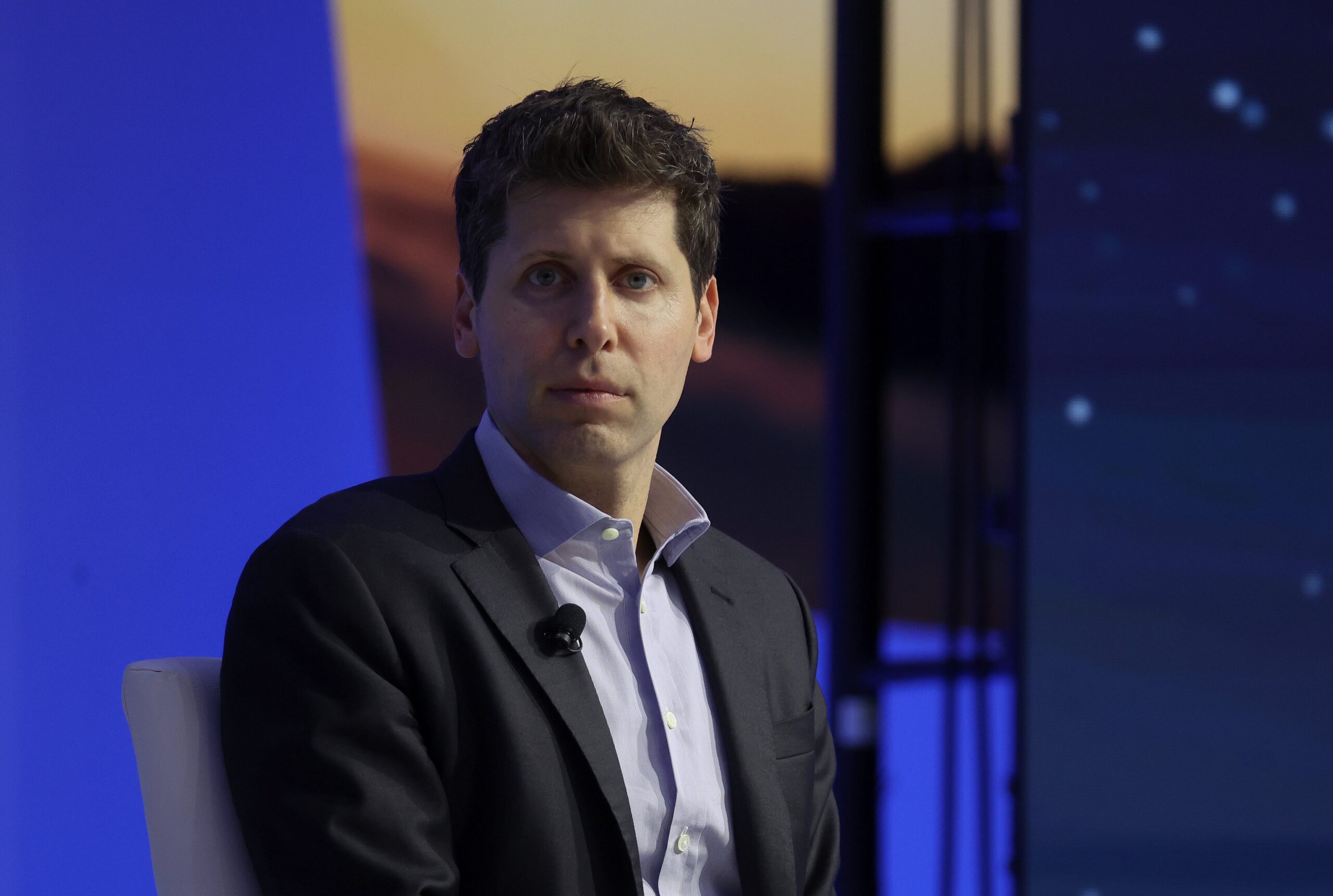 sam altman looking at the camera in suit